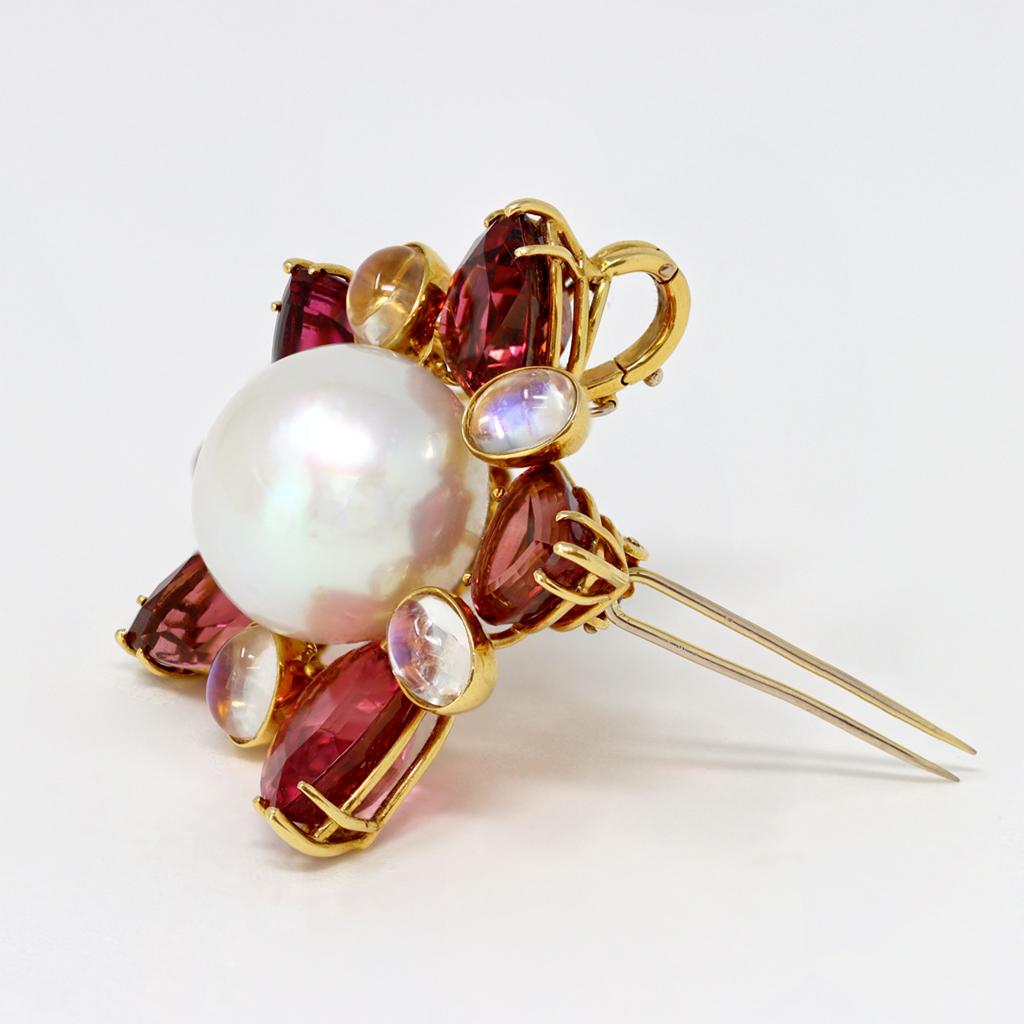 The stunning star-shaped brooch pendant was created and signed by the famous jewelry designer Prince Dimitri circa 1980-90. It features a rare 20.7 millimeter South Sea round White pearl adorned with pear-shaped rubellite tourmalines and oval