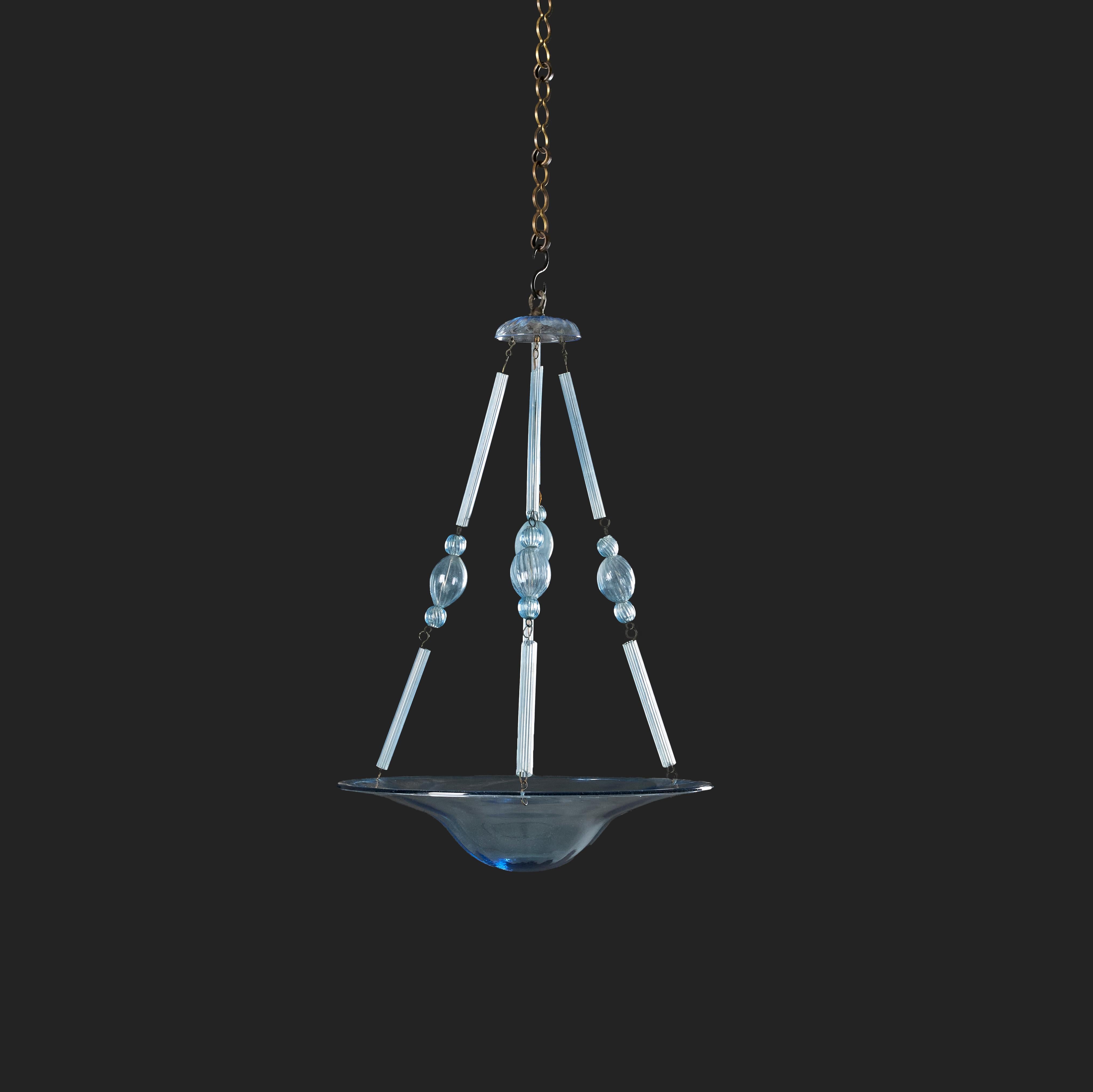Italy, circa 1940
A rare 1940s blue Murano glass hanging light attributed to Vittorio Zecchin, the dish element supported by fluted glass stems and orbs.

Height   61.00cm
Diameter  40.00cm

Please note:
Currently wired for the UK with single bulb