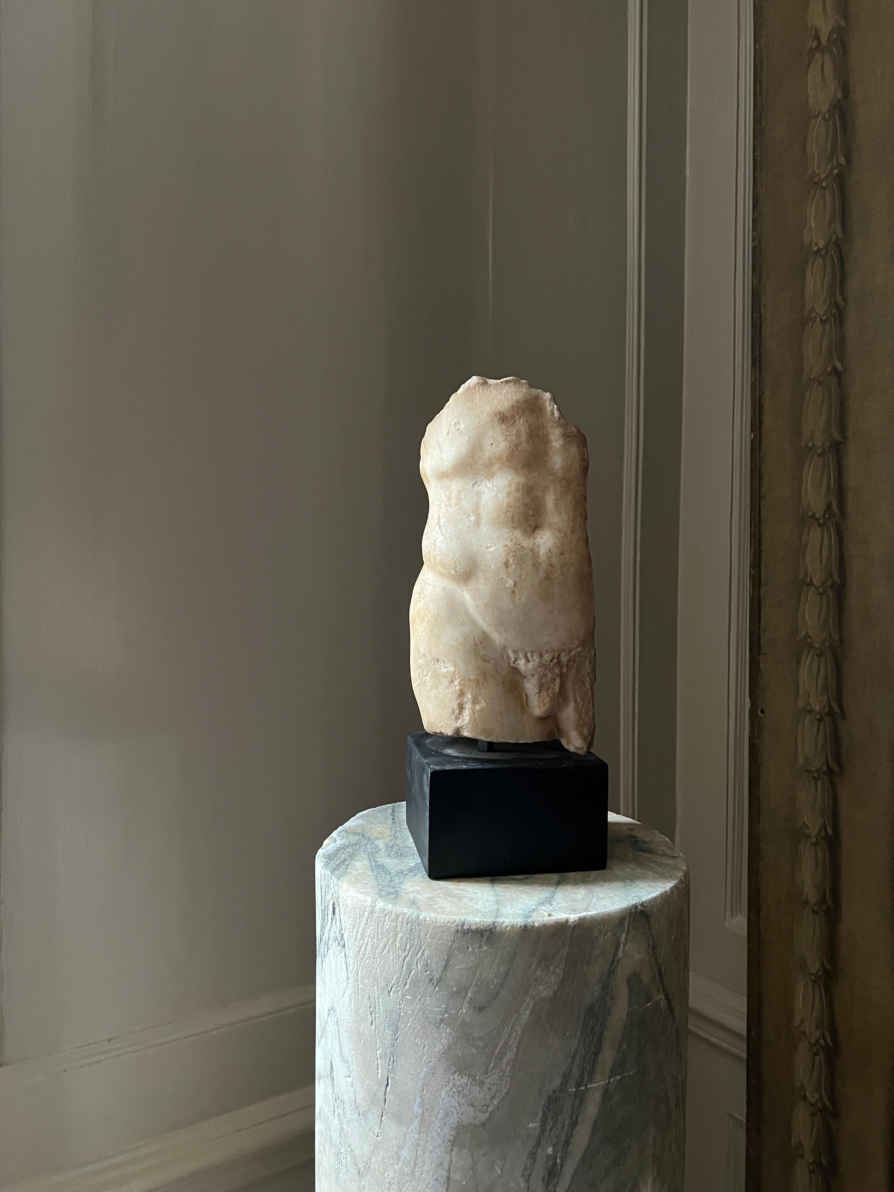 A Rare ancient Roman marble torso fragment in contrapposto, c. 1-2nd century AD. Mounted on a square plinth. Please enquire for details. 

Measures - 33cm H x 13cm W x 11cm D.