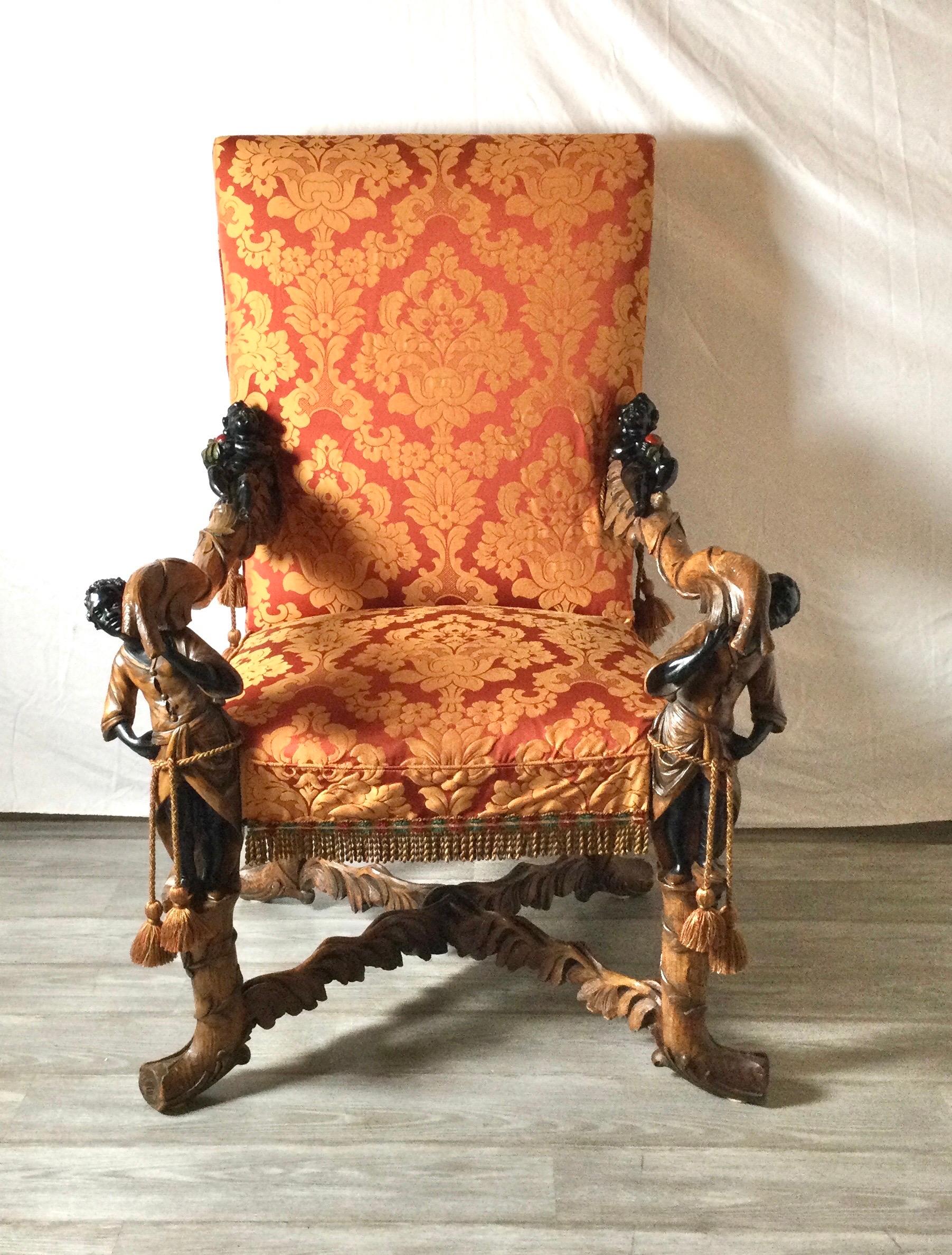 Exceptionally hand carved 19th century Lolling chair with hand carved branch and leaf motif with ebonized figures on the top and bottom of the arms. This chair is a larger scale with impressive workmanship. The custom high quality damask slip cover