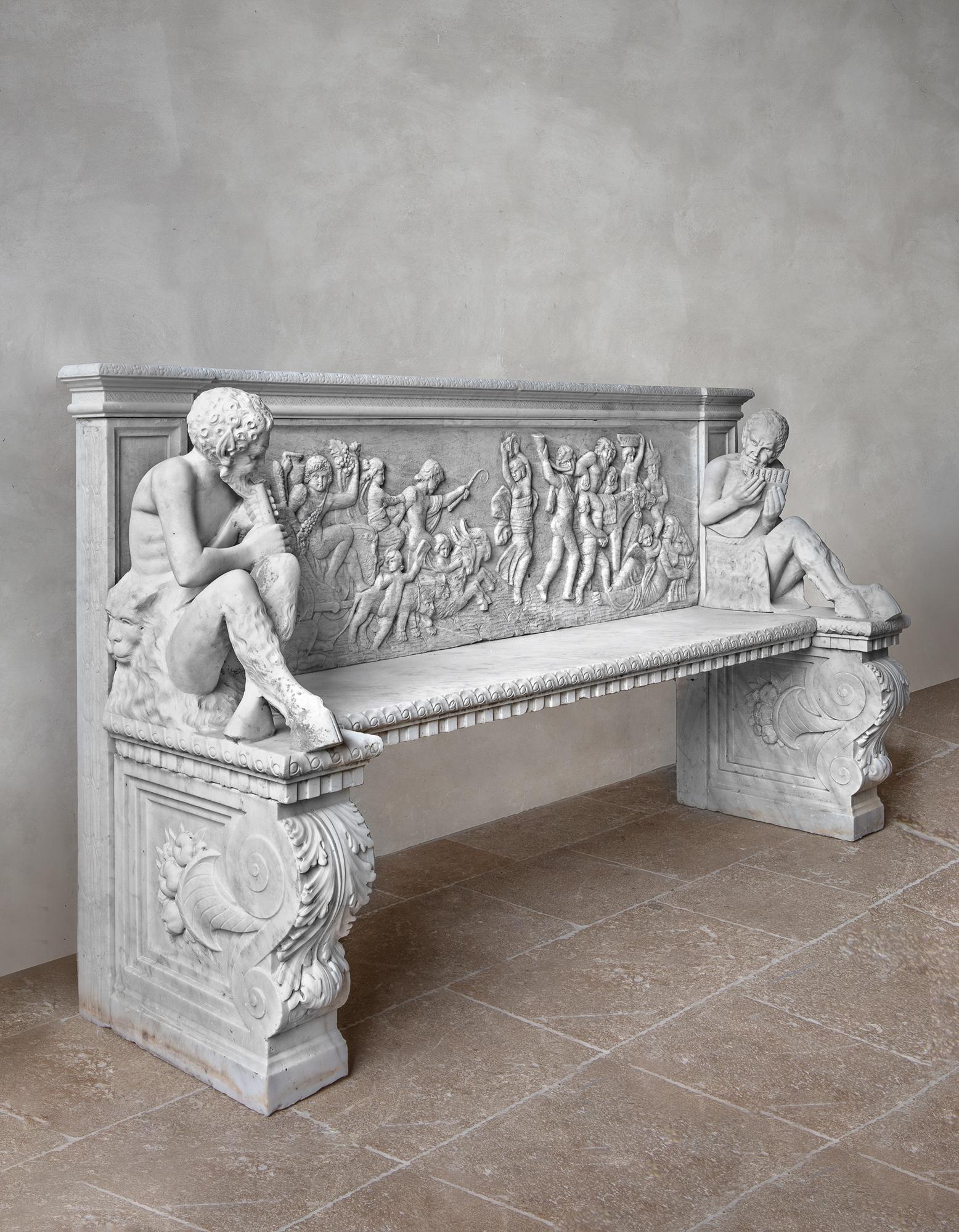A rare and impressive carved white marble neoclassical bench. Late 19th century Italian, Florentine.

Backrest with relief carving of Bacchus in triumphal procession, armrests of reclining satyrs with musical pipes, on acanthus leaf carved