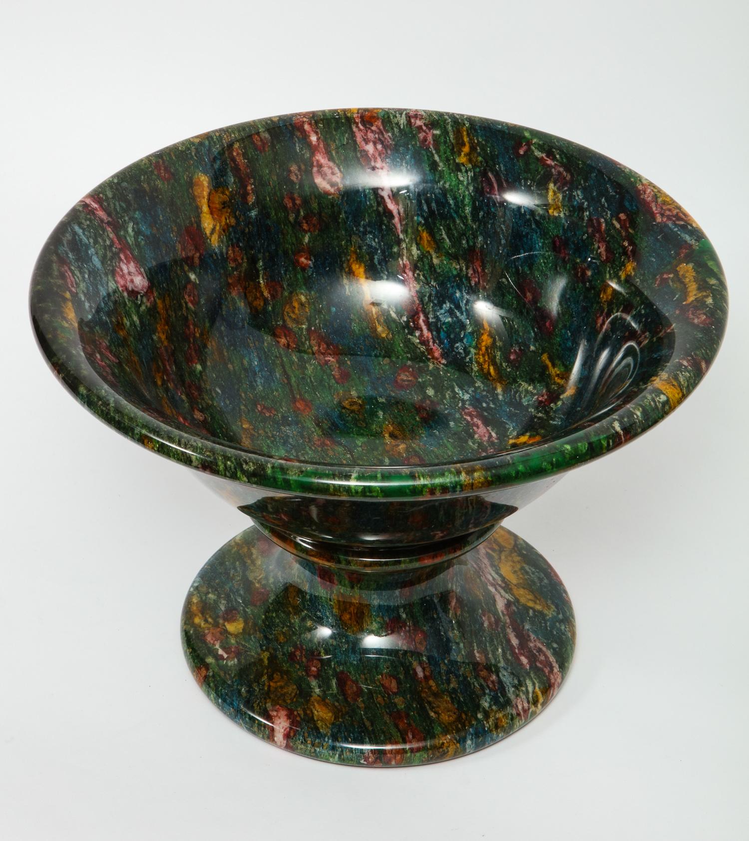 A rare and large decorative green jasper bowl,
Suitable for use as a fruit bowl or other presentation. The color is deep rich green with yellow, ochre, burgundy and white veining. Raised on a shaped stem and foot.

This green variety of jasper