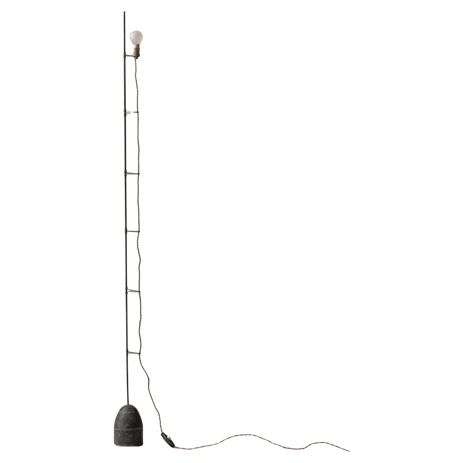 A rare and likely one-off minimal floor lamp in metal and concrete, France 1950s