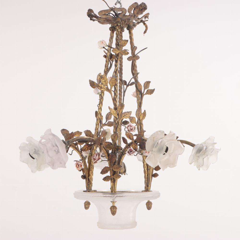 A rare and unusual French bronze chandelier C 1910 having six arms, each adorned with vines, leaves and porcelain flowers, and terminating in a frosted glass bloom, all surrounding an unusual basket form glass shade/vase at the center bottom of