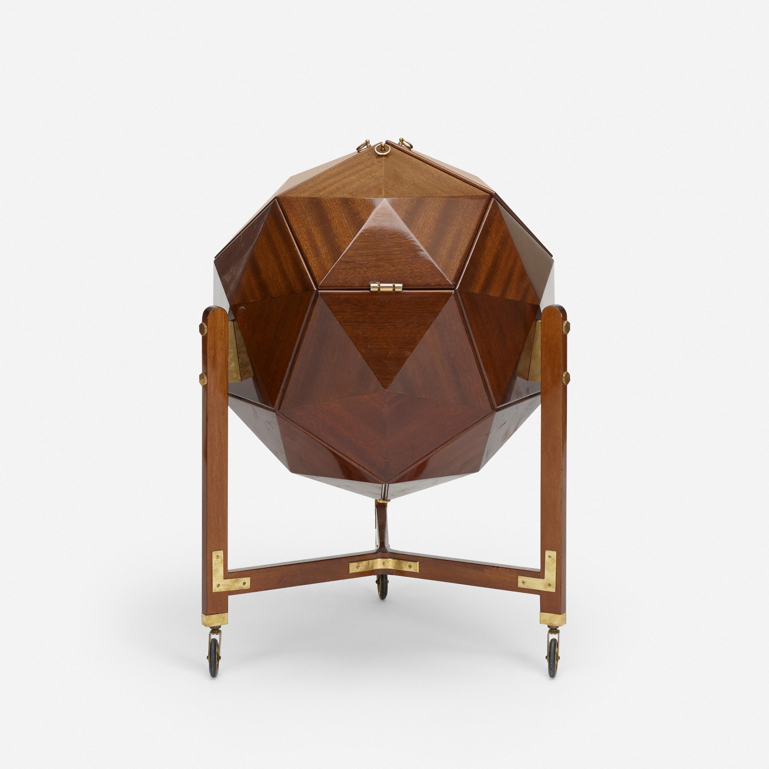A rare and unusual polyhedron bar cabinet by M. Vuillermoz

Dambrine
France, circa 1960
mahogany, brass

Three mahogany doors lined in brass open to reveal storage for bottles and barware.

Doors are fitted with brass ring pulls.
 
Legs