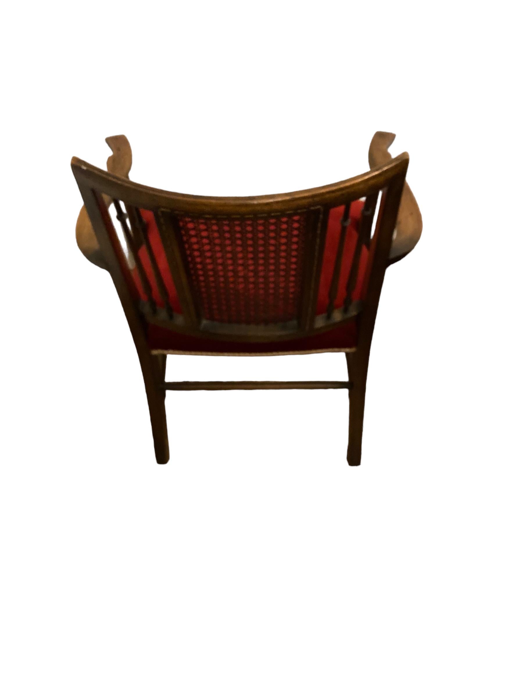 A rare Antique Beech Wood X Framed Cane back Arm chair. With its unusual Savonarola looking frame makes this wonderful chair both charming and a practical hall or bedroom chair that fits in to any design of interior. A solid structure with a new red