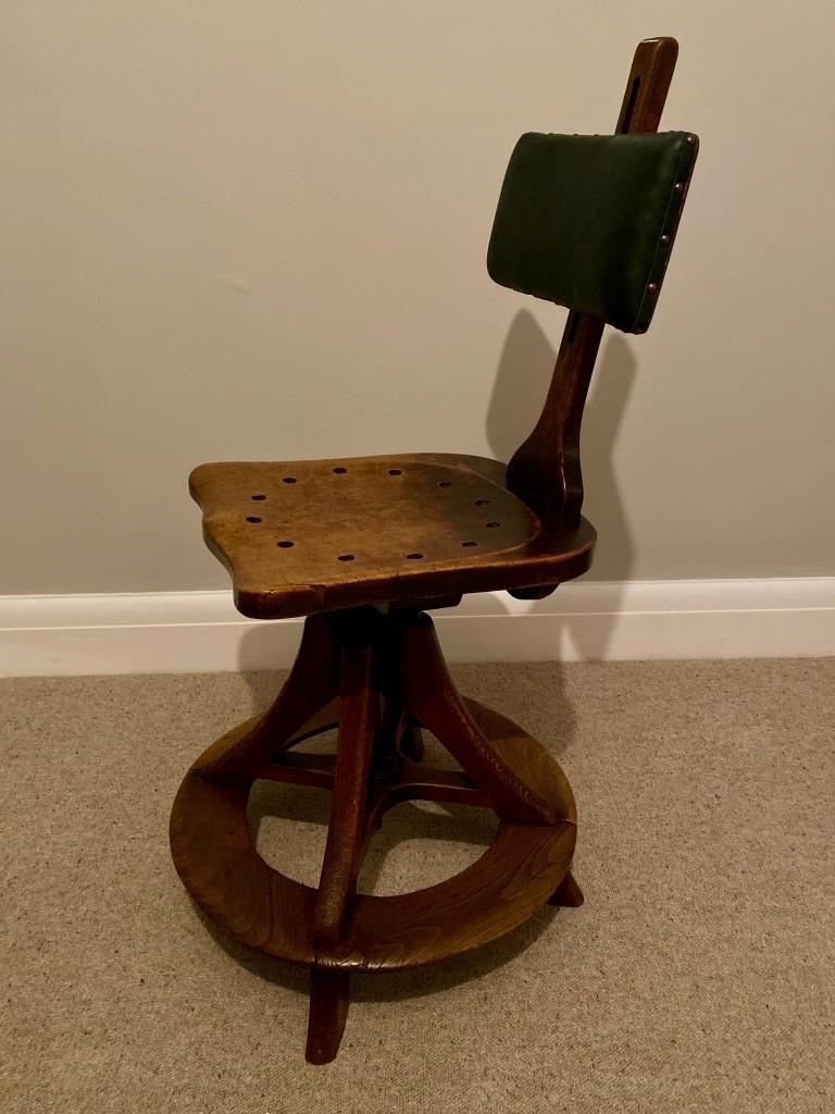 A rare antique Industrial Draughtsman chair by H Mealey Ltd of High Wycombe. Having been sympathetically restored and reupholstered professionally. The seatback has been finished in leather with stud detail and is adjustable via a good solid