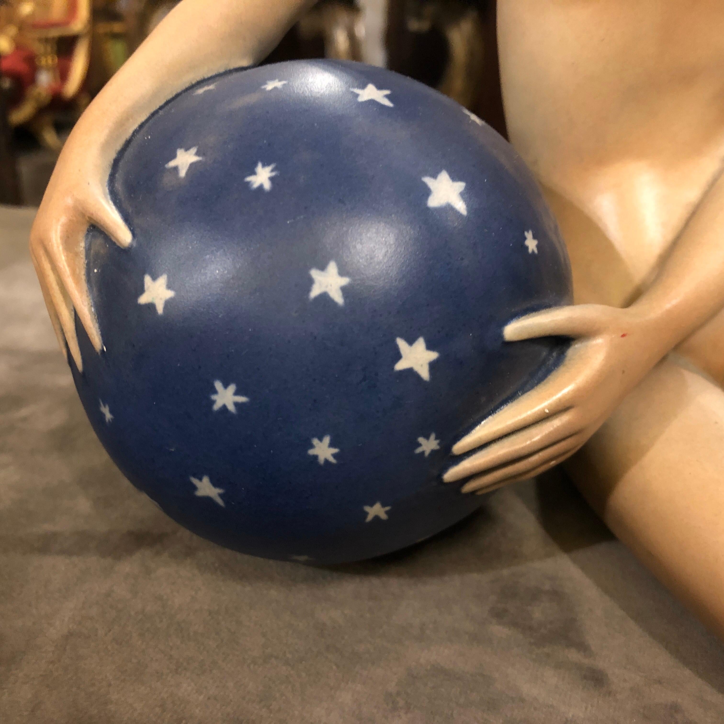 An Italian woman statue made in Italy in the 1940s by le Bertetti, very famous small factory that operated from 1932-1952 in Turin. It's totally handcrafted and painted and depicts a woman holding a ball.