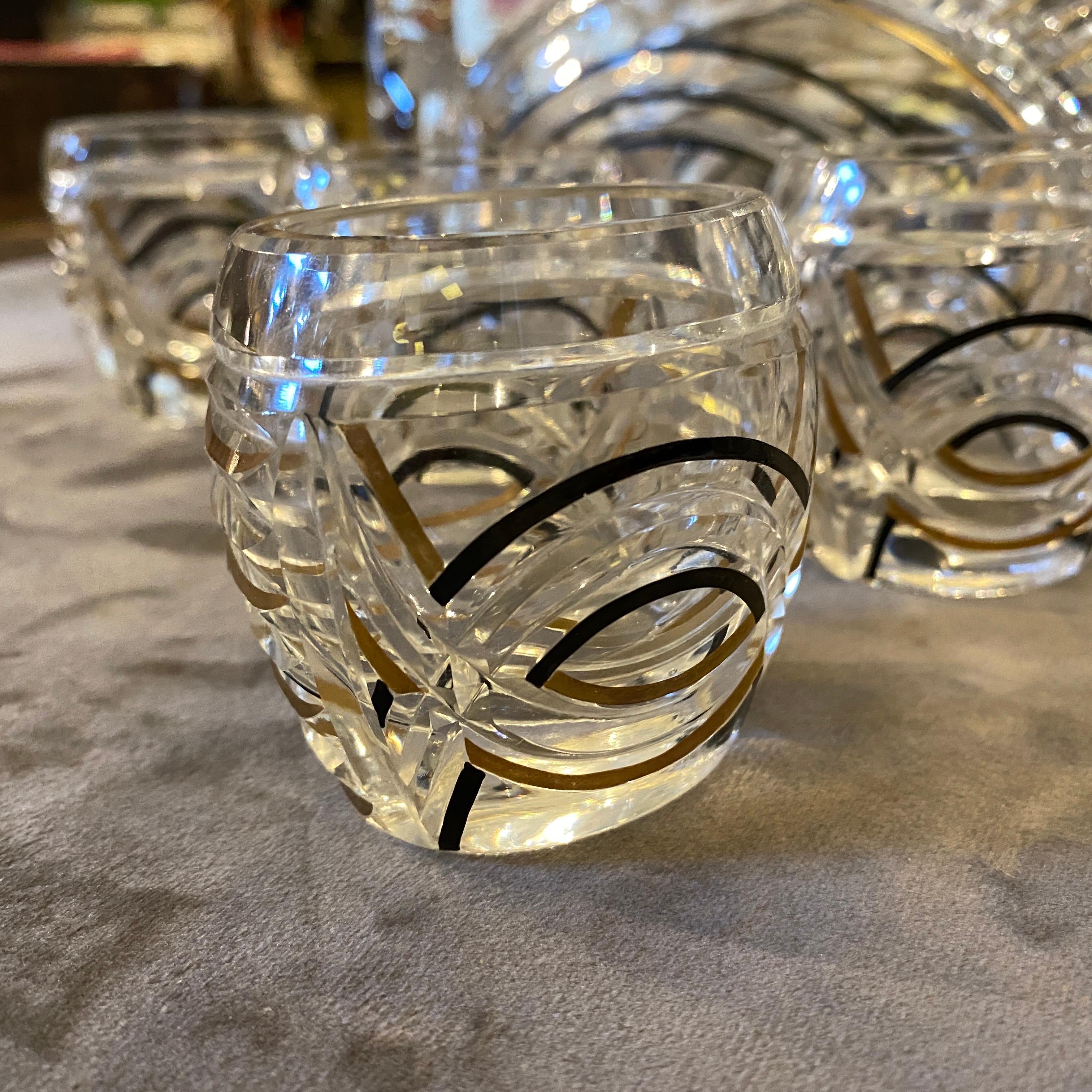 Stylish Art Deco liquor set made in Italy in the 1930s, engraved crystal with black and gold decor is in perfect conditions. Oval bottle dimensions declared. Glass height is about 3 inches.
