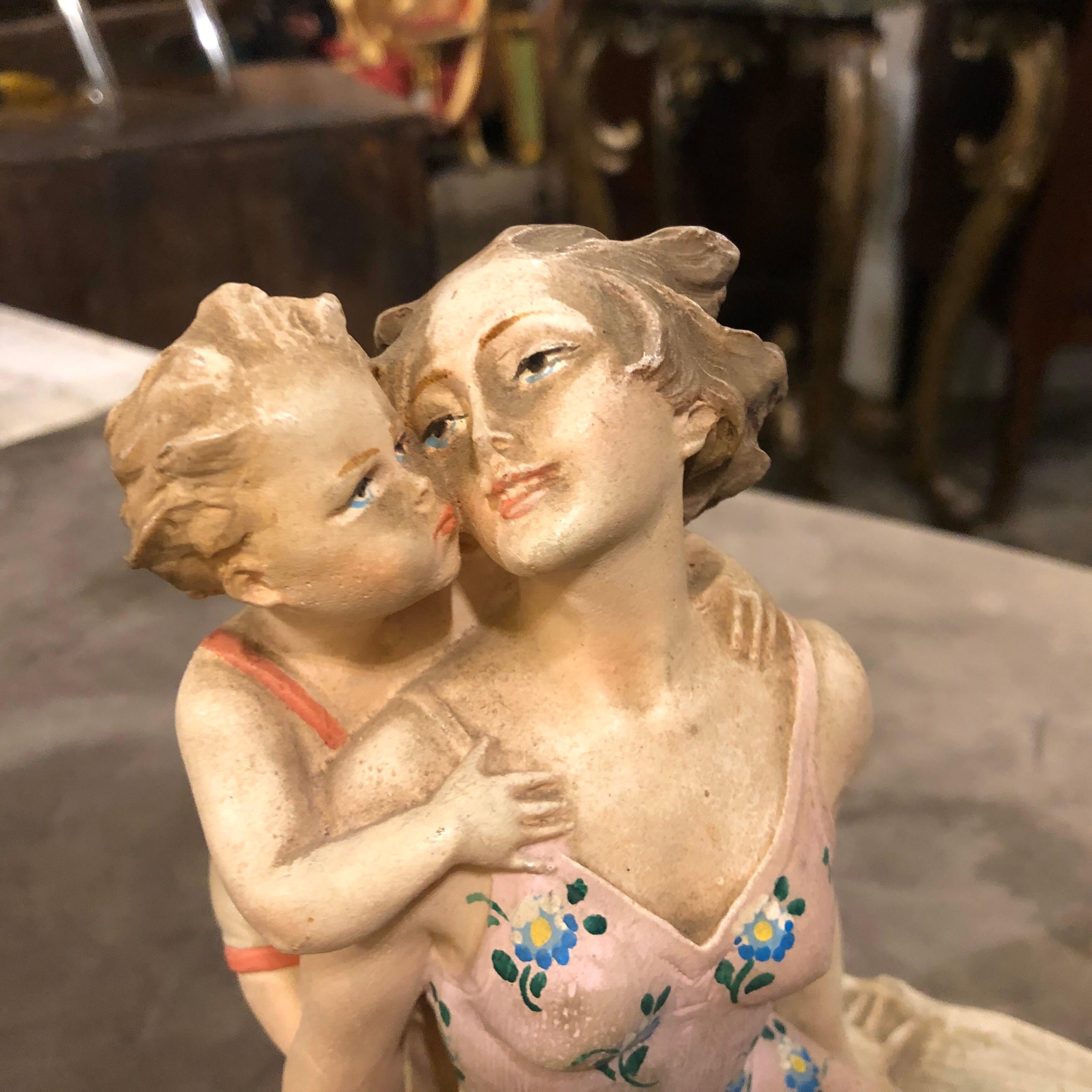 An Art Deco Italian statue depicting a woman and a baby at the beach, it's in perfect conditions.