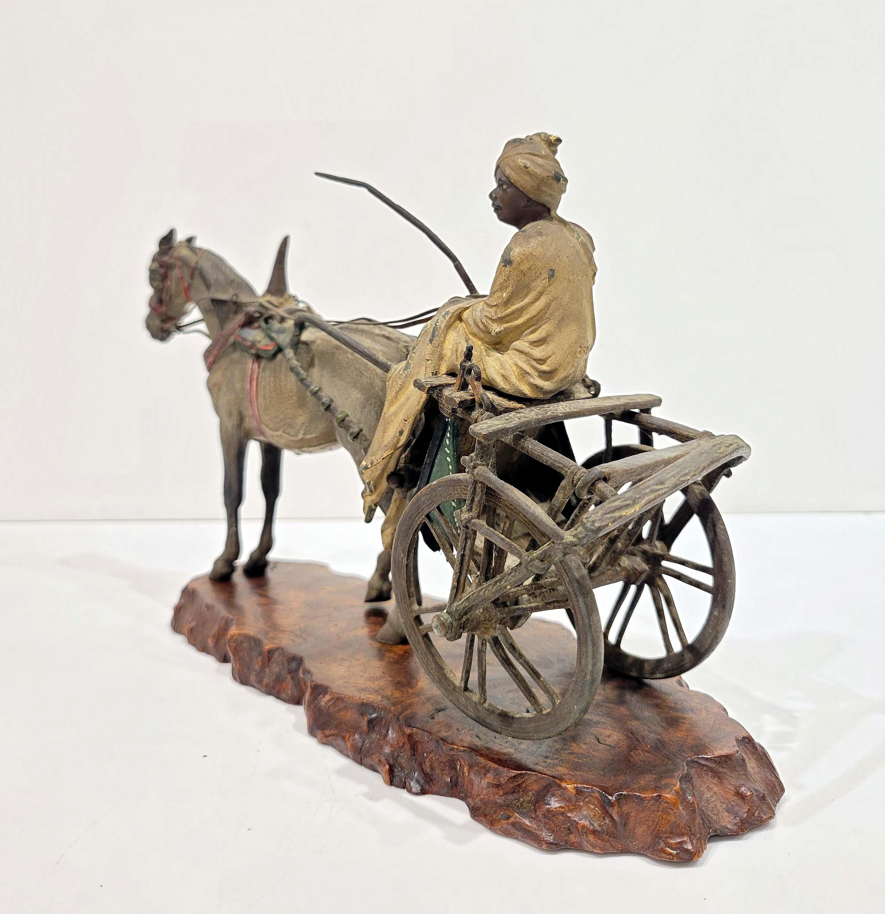 Depicting an orientalist man on a horse driven carriage. Beautifully polychromed on cast bronze with excuisite details. Stamped in 3 places with Bergmann marks numbered and foundry marks. On a wooden base.
Minor losses to the cold painting on his