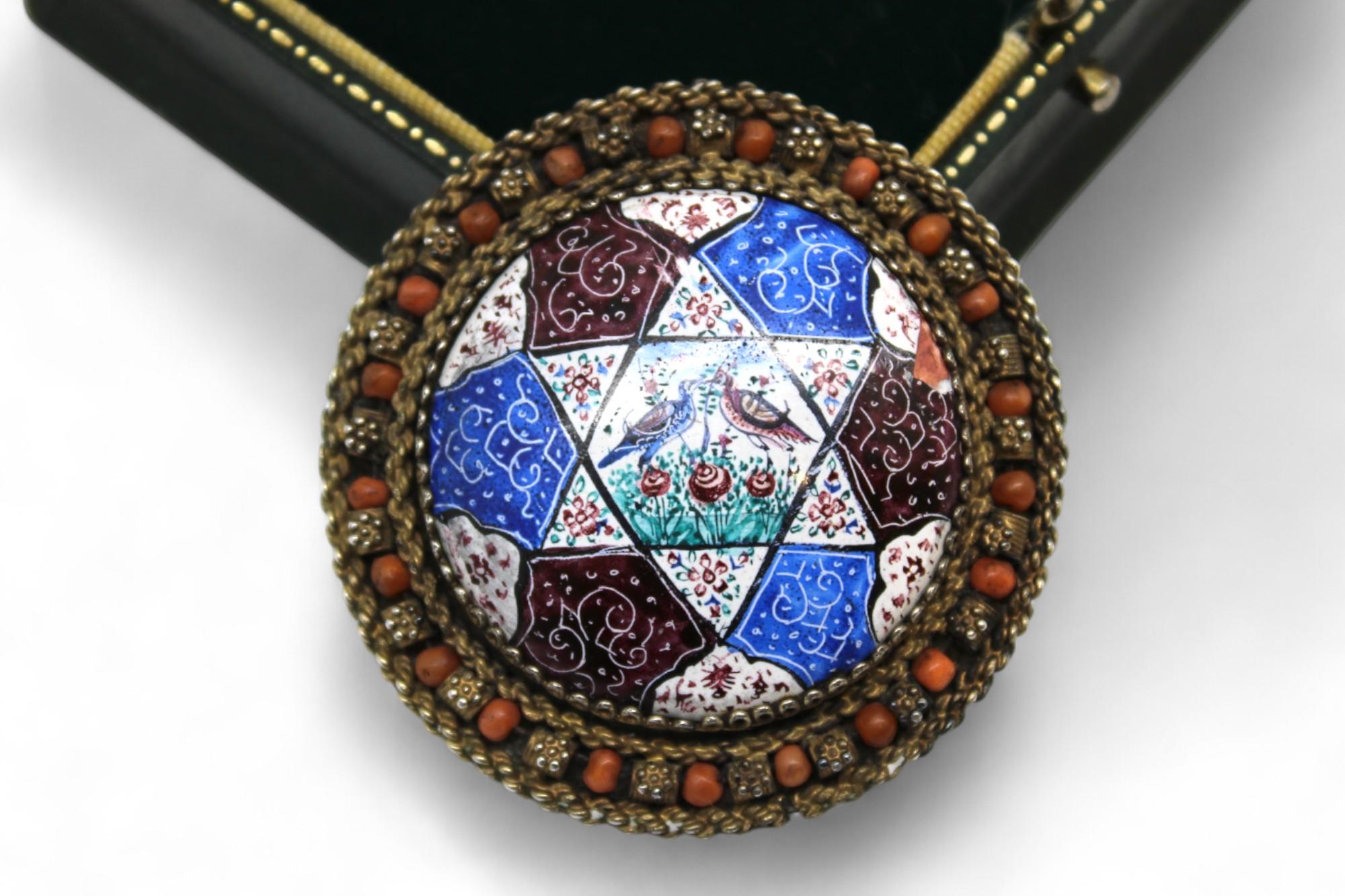 This exquisite and rare brooch, crafted by the Bezalel School in Jerusalem during the 1950s, is a masterwork of Israeli Judaica artistry. Executed in fine silver filigree and vivid hand-painted enamel, the piece exemplifies the refined craftsmanship