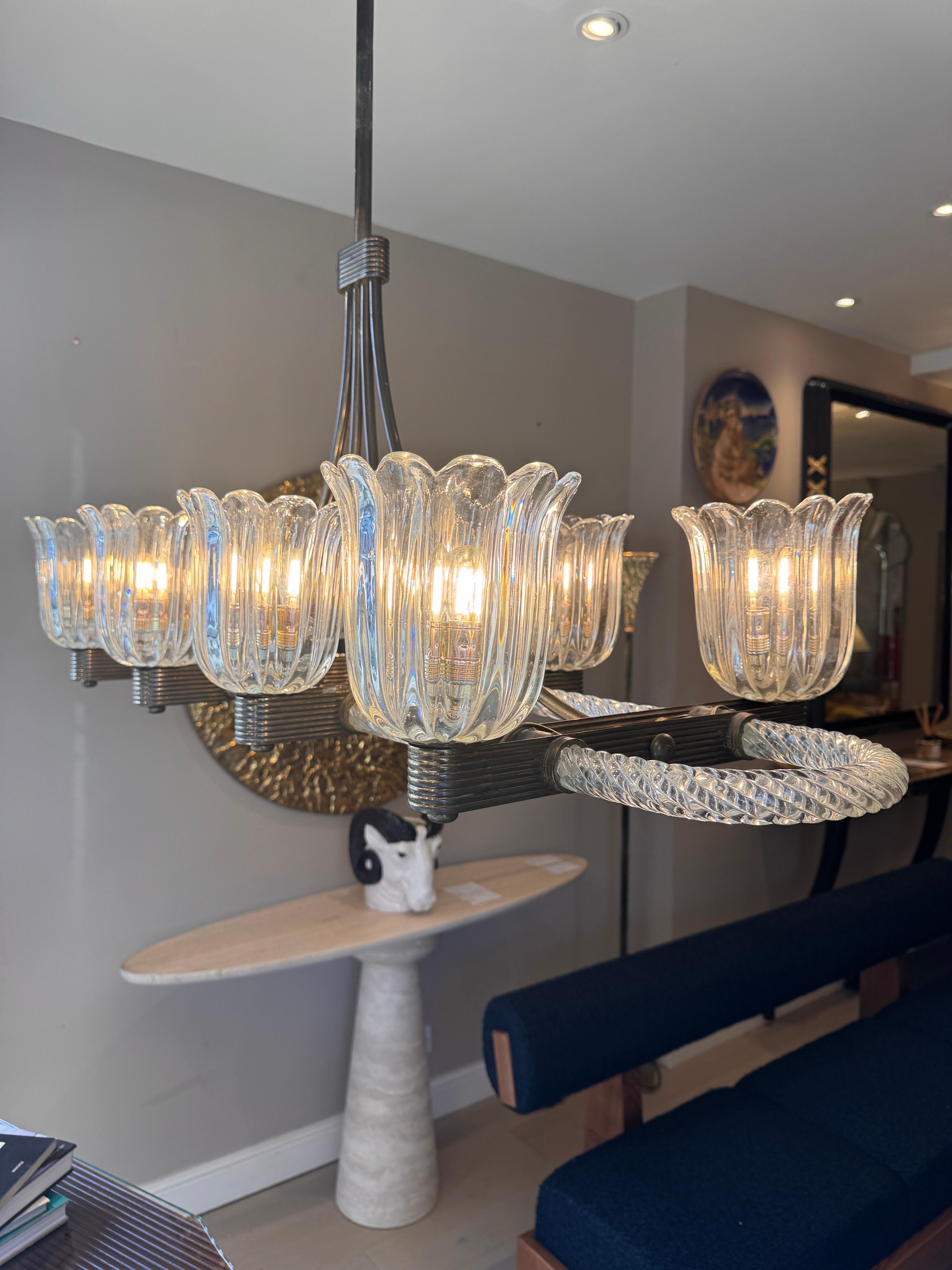 A very rare horizontal brass mounted 8 arm Murano glass chandelier designed & produced by the glass master Ercole Barovier in the early 1930s . 
All glass is intact with natural patina to the brass structure. 
