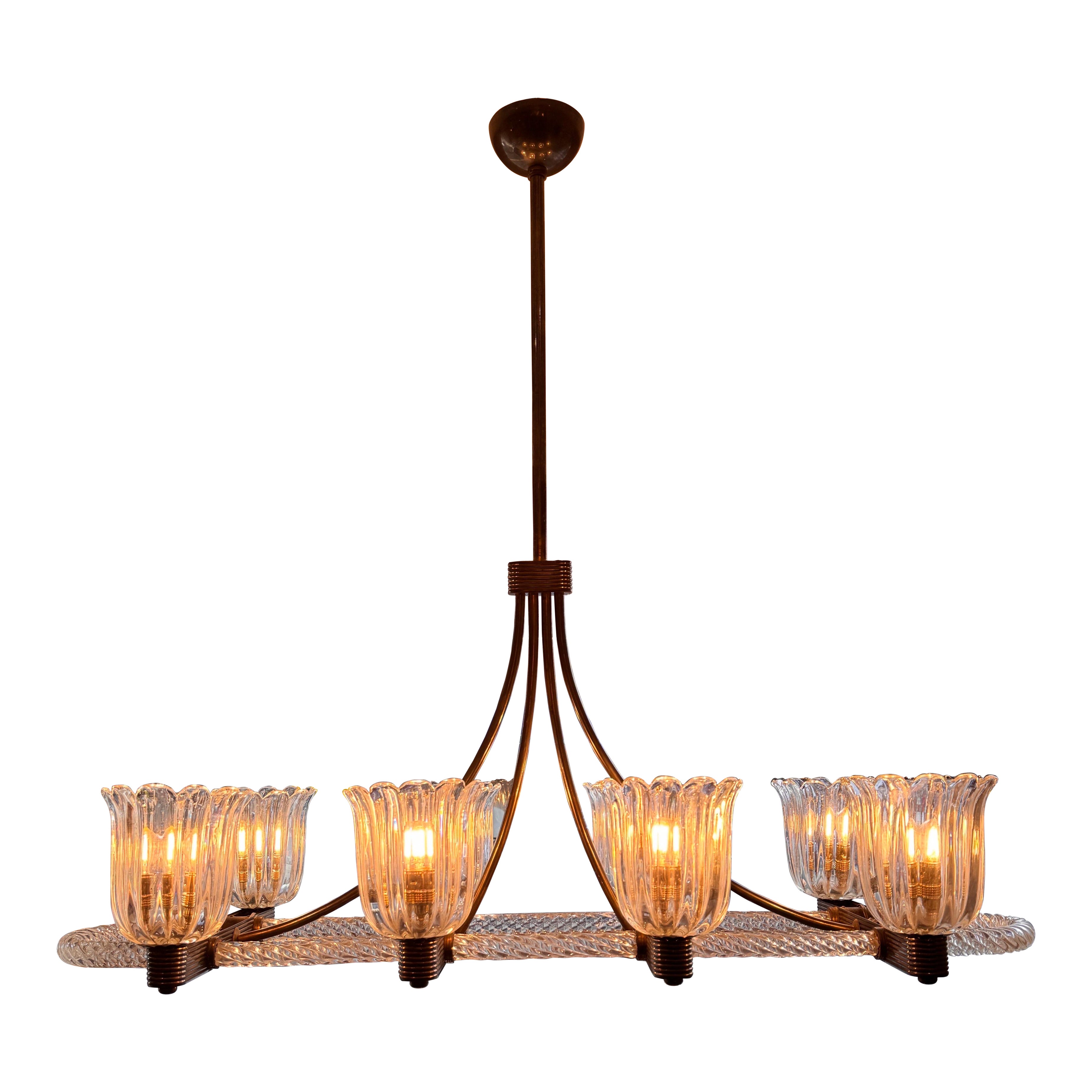 A rare brass mounted 8 arms horizontal chandelier by Ercole Barovier For Sale