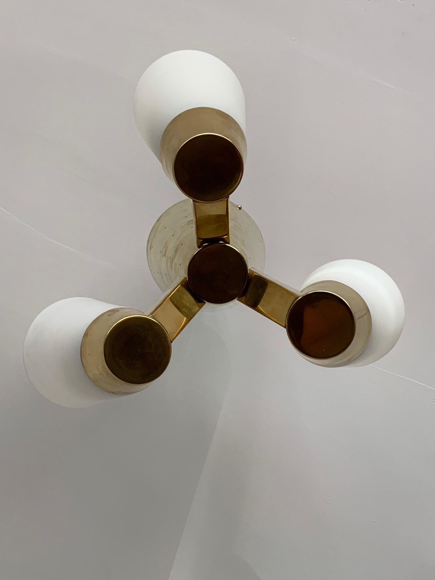 A rare and unusual chandelier-ceiling mounted, by Itsu, Finland, circa 1950s. Polished brass and opaline glass. This is model # ER 109/3- see catalog pic.