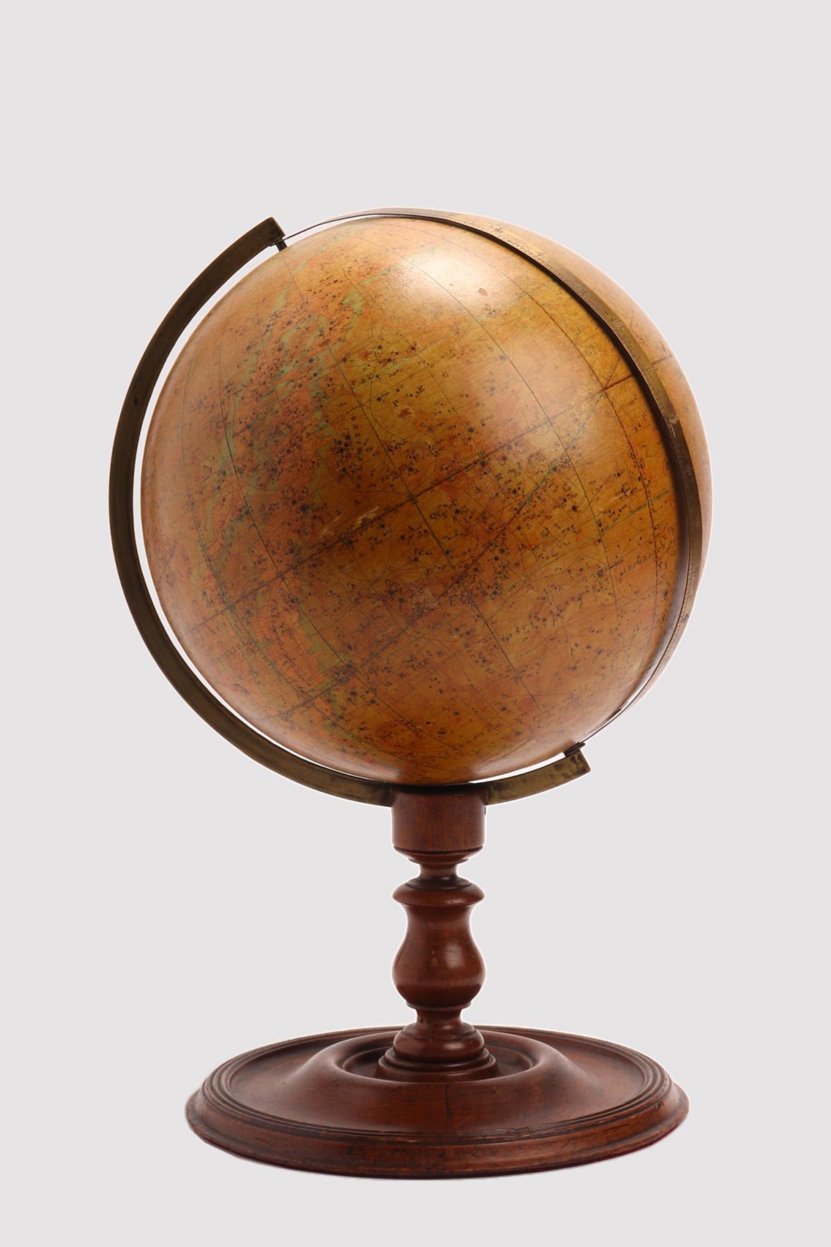 Celestial globe over a wheel turned wooden base, with round foot, moved profile and tall leg, with a perfect patina, is placed this celestial globe, edited by J. Wyld, Charing Cross East, London. The globe is made out of papier maché, finished with