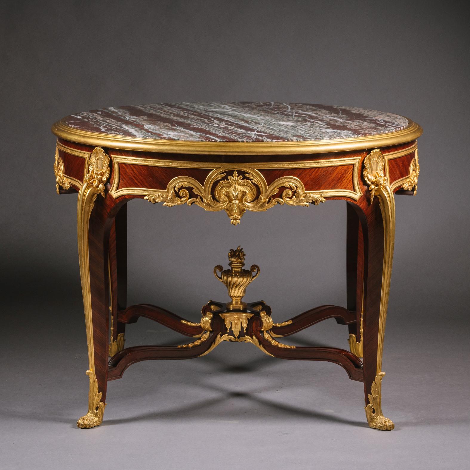 An important and rare gilt-bronze, mahogany and Bois Satiné centre table, with campan rubané marble top. By François Linke.
Linke index number 1103.
The gilt bronze on the stretcher variously incised and numbered 'FL/5842'
The circular top inset