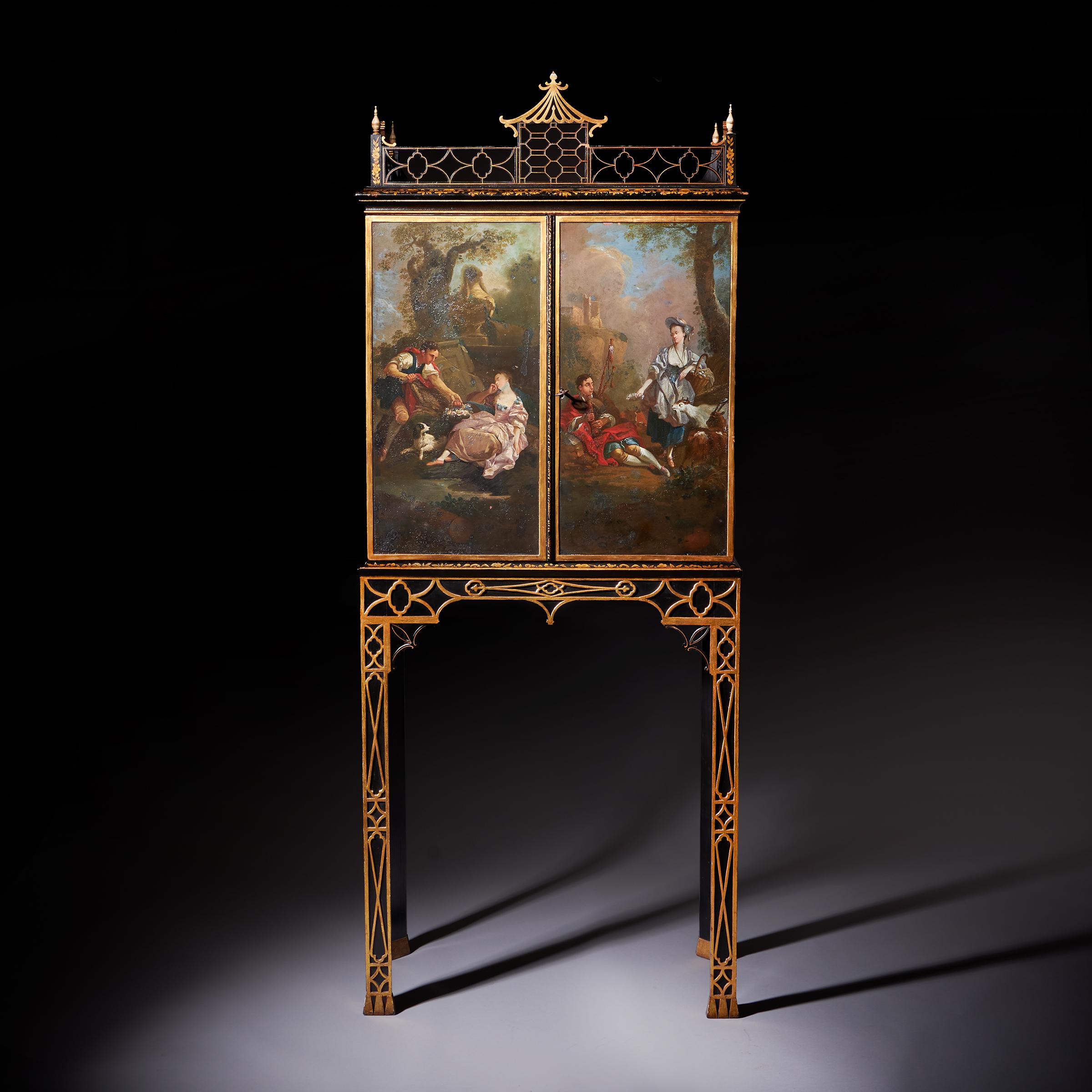 A Fine and Rare George III Chinoiserie Cabinet on Stand, Circa 1760.

A rare George III cabinet on stand in the Chinese Chippendale manner, circa 1760. England. The fret pierced ‘Pagoda’ galleried top above two cupboard doors, each painted with