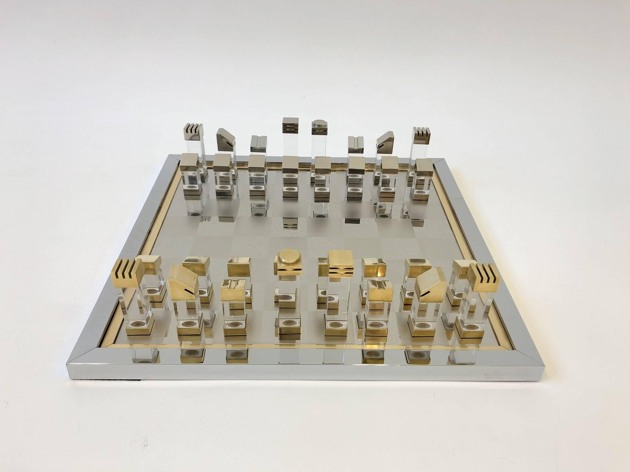 A spectacular 1970s Italian chess set by Romeo Rega. Constructed of polish chrome, brass and clear acrylic. The board is signed Romeo Rega made in Italy on the side (see detail photos).

Dimension: 
Board 16.75” wide 16.75” deep and .75