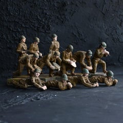 A rare collection of twelve mid 20th Century WW2 hand carved combat figures