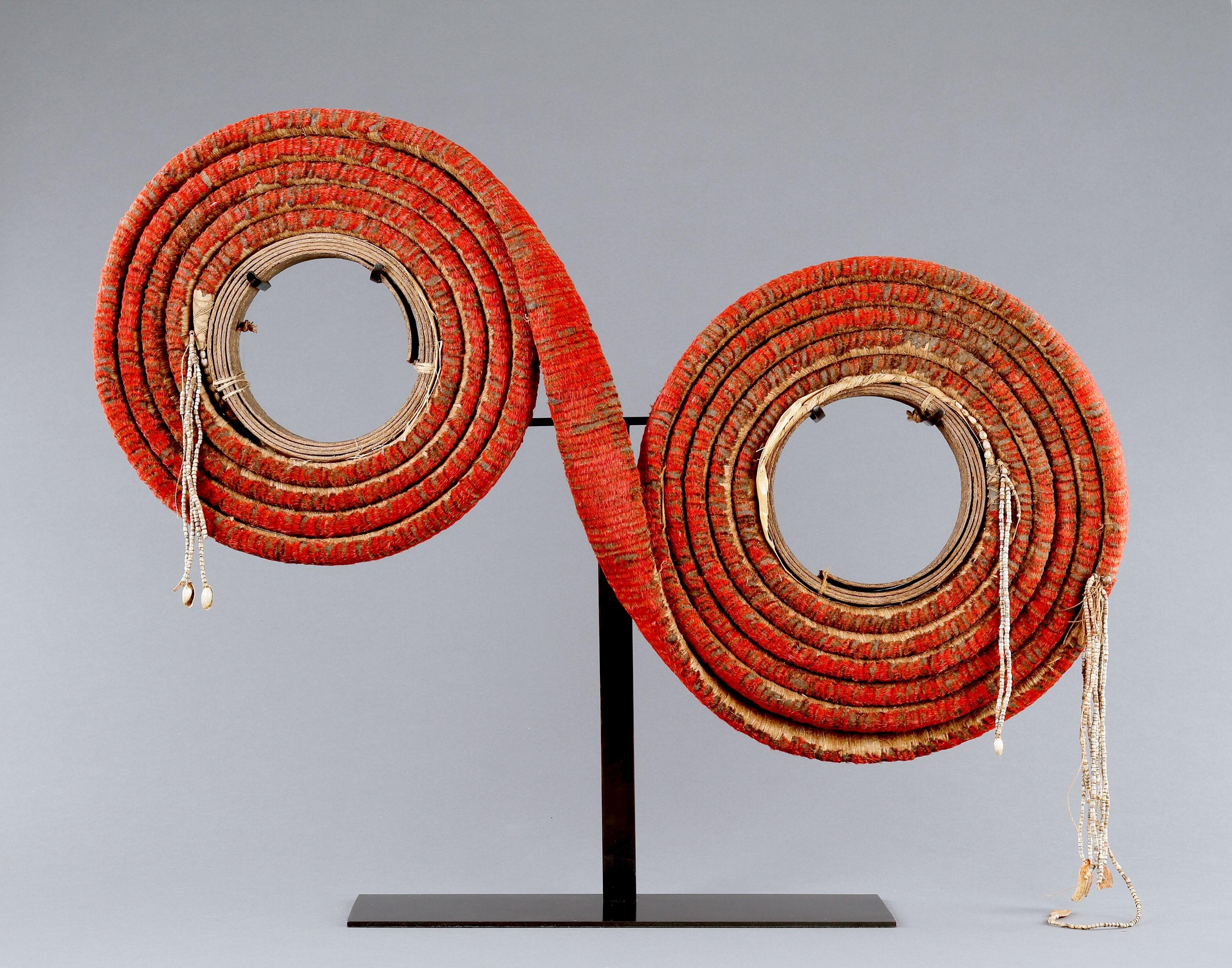 A Rare Double Roll of Pacific Solomon Islands, Santa Cruz, Red Feather Currency ‘Tevau’

Plant fibre, bark strips, red bird feathers, small shells, glass beads 

Solomon Islands 



19th Century



Size: 

approx: 45cm high, 80cm wide, 6.5cm deep