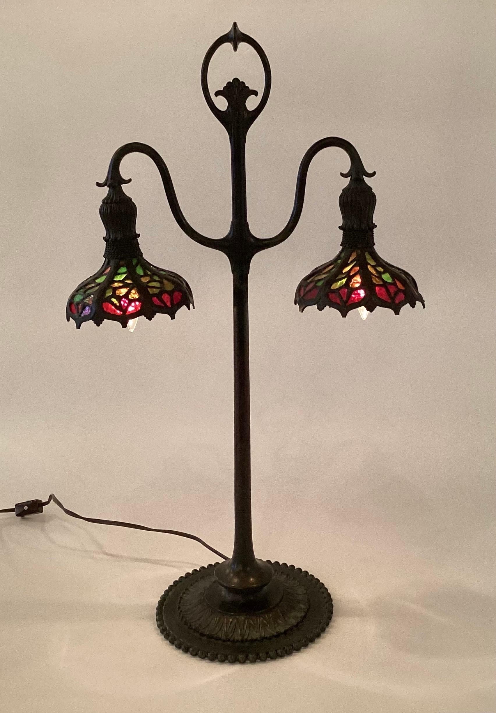 A Rare high quality double student lamp attributed to Bigelow, Kennard by Enos Lamp in NYC, very good condition with original shades and patination to the bronze The piece has a questionable mark on the base of Tiffany Studios which was a common
