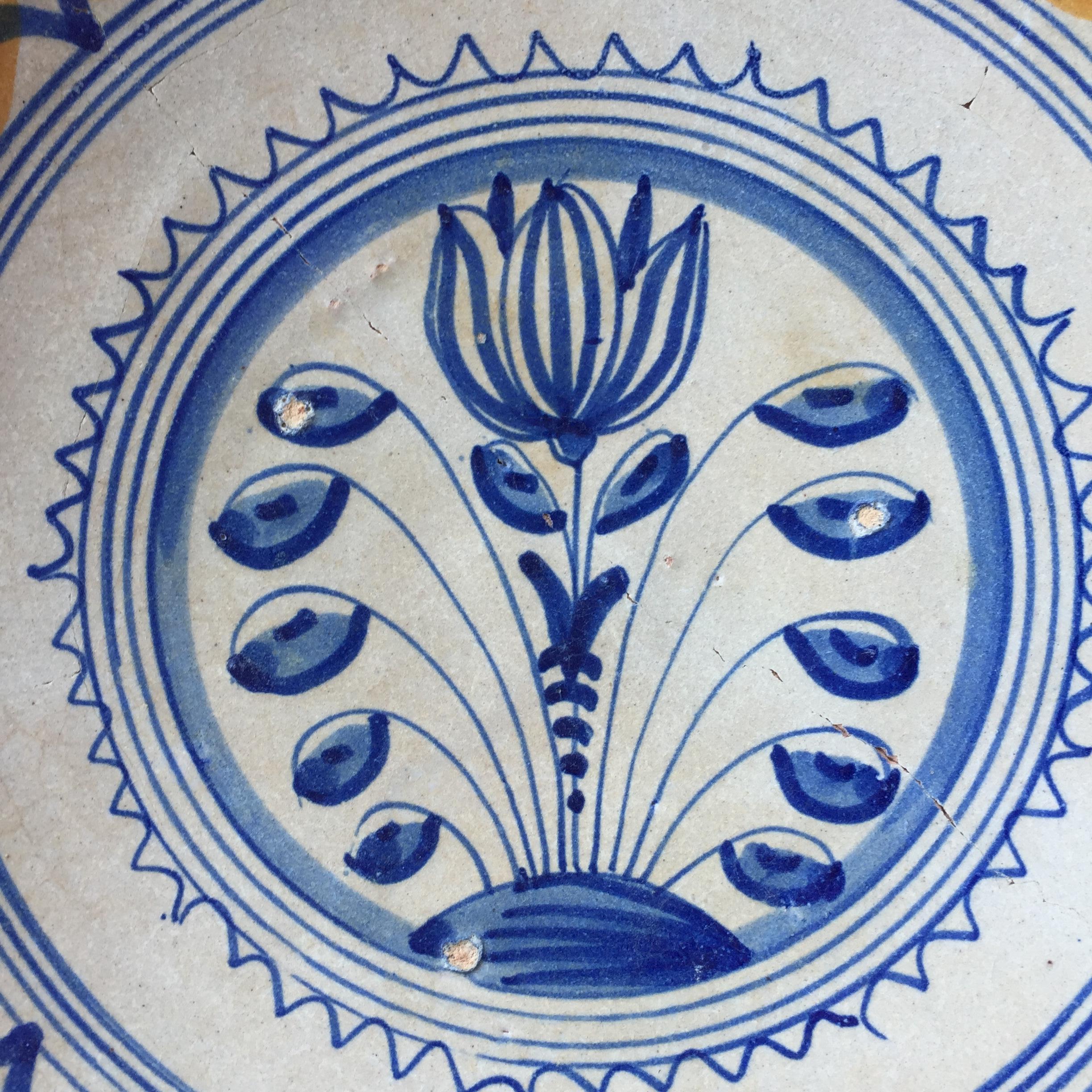 A rare Dutch Majolica plate with a decoration of a tulip.
Northern Netherlands, probably made in the city of Rotterdam.
Made 1620 - 1640

Dutch majolica is one of the more rare ceramics known, especially in a condition where it is almost