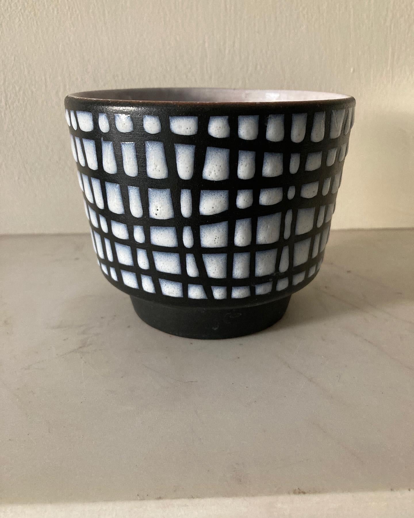 An early rare example of black and white glazed ceramic cache pot by Roger Capron. This piece is unsigned which shows it is an early example, when the bases of his pots were not glazed. Stamp 12/T with an indistinct mark. A good piece of Vallauris