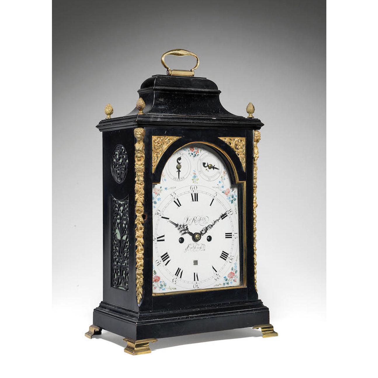A RARE EBONISED TABLE CLOCK WITH PIVOTTED DE
BETHUNE TYPE ESCAPEMENT
John Russell, Falkirk
The bell top case with handle and four cone finials over pierced wooden sound frets on a plinth base and brass ogee bracket feet, the repainted 8 inch dial