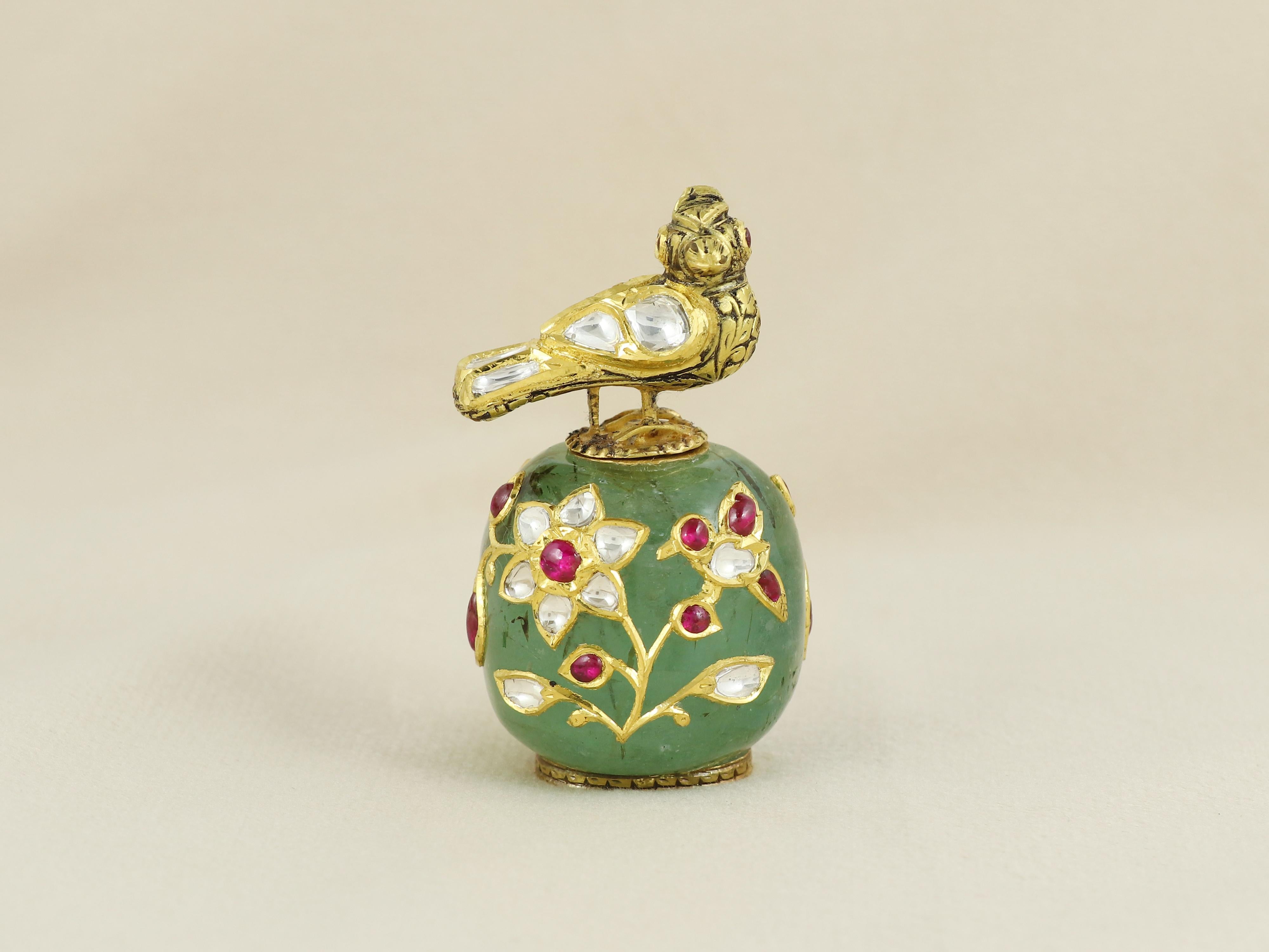 This extraordinary itradani, or traditional snuff bottle, is a one-of-a-kind objet d’art meticulously carved from a single piece of natural Russian emerald tumble—an exceptional feat of craftsmanship. The emerald has been hollowed from inside