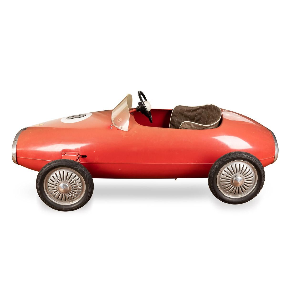 20th Century Belgian made “Ferrari“ model pedal car, of metal construction, red painted monocoque steel body, number 8, treadle pedals to cranked rear axle, steel panel seat with brown vinyl cover, plastic steering wheel, perspex windscreen, alloy