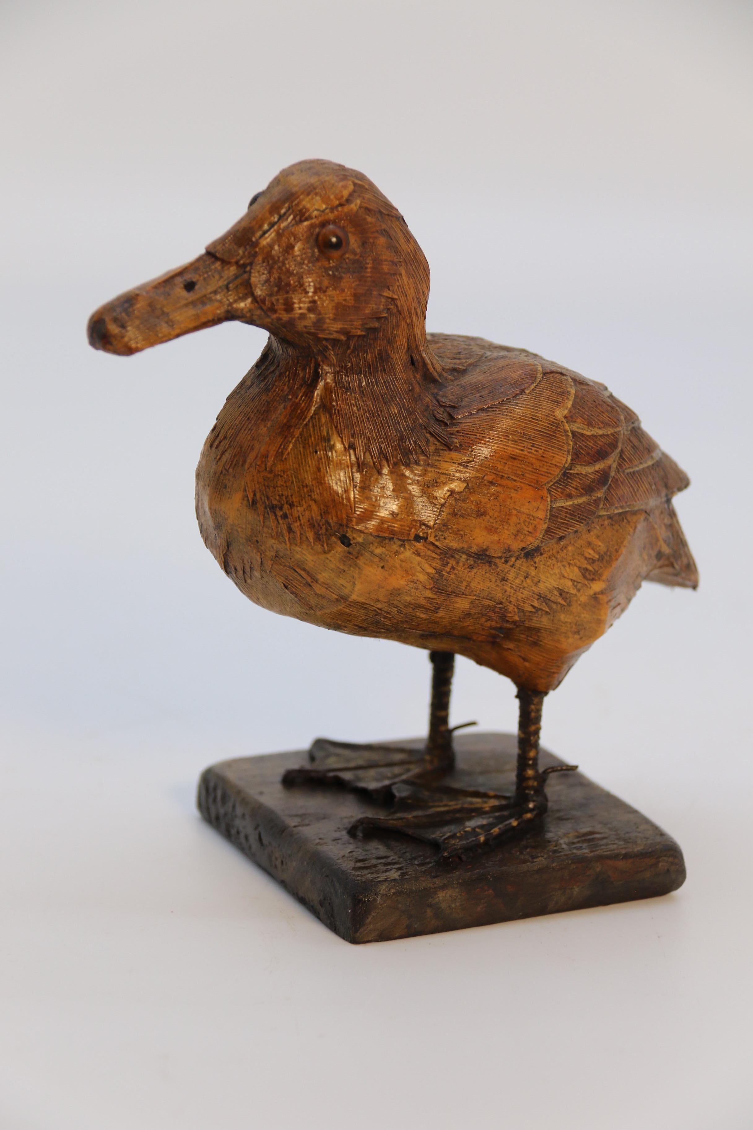 This most rare and unusual folk art study of a duckling is remarkable in its fine detail.  It is constructed of papier mâché which is then been veneered with cut and shaped straw which shows all of the different layered feathers. The eyes are made