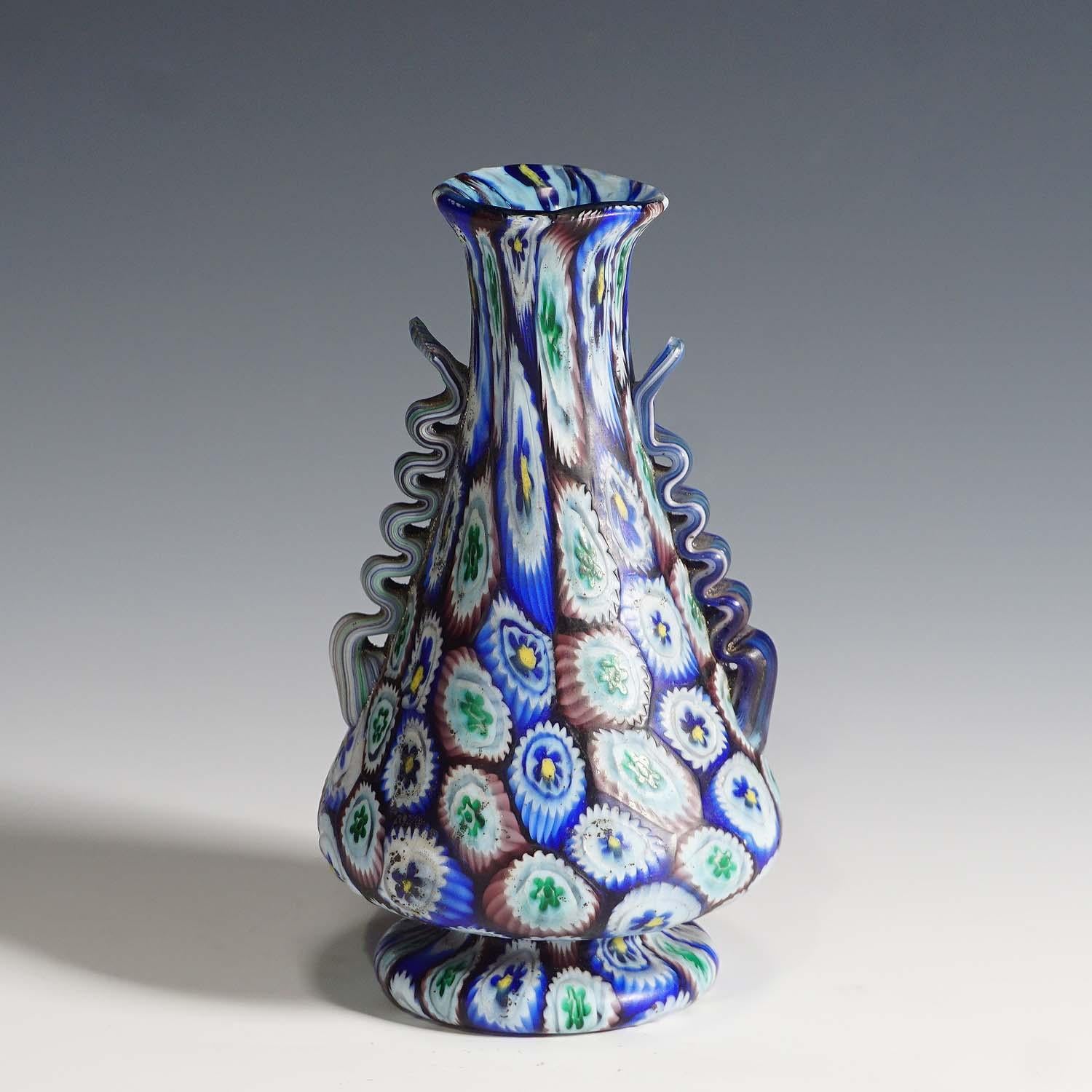 A very nice murrine glass vase with aplied handles, manufactured by Vetreria Fratelli Toso, early 20th century. Polychrome murrine in blue, green and purple, matt surface finish.

Lit.:
marc heiremanns, fratelli toso murano 1902-1980, stuttgart