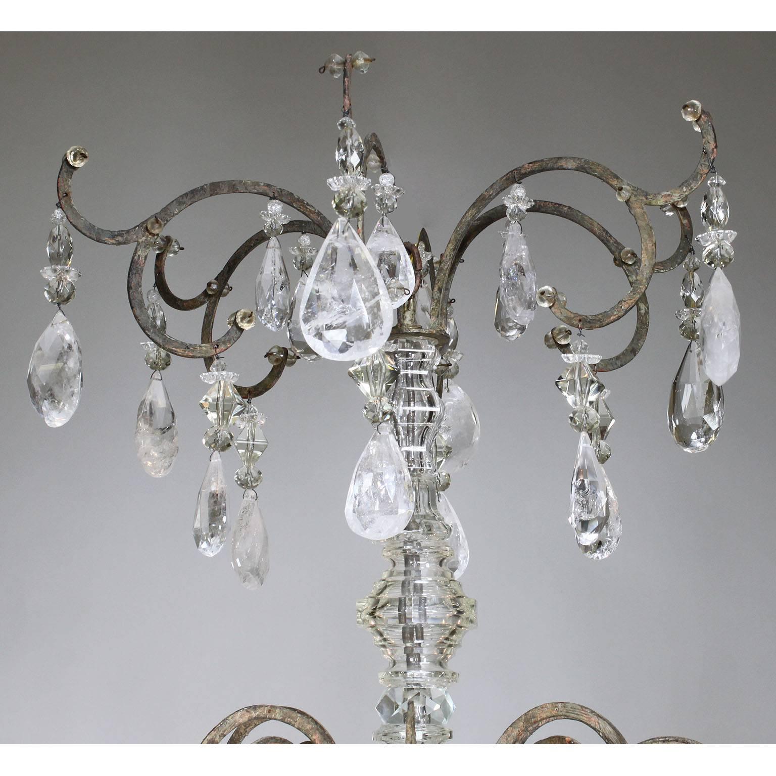 A rare French 19th-20th century Louis XV style six-light patinated metal and rock-crystal chandelier. The thin metal frame surmounted with six 