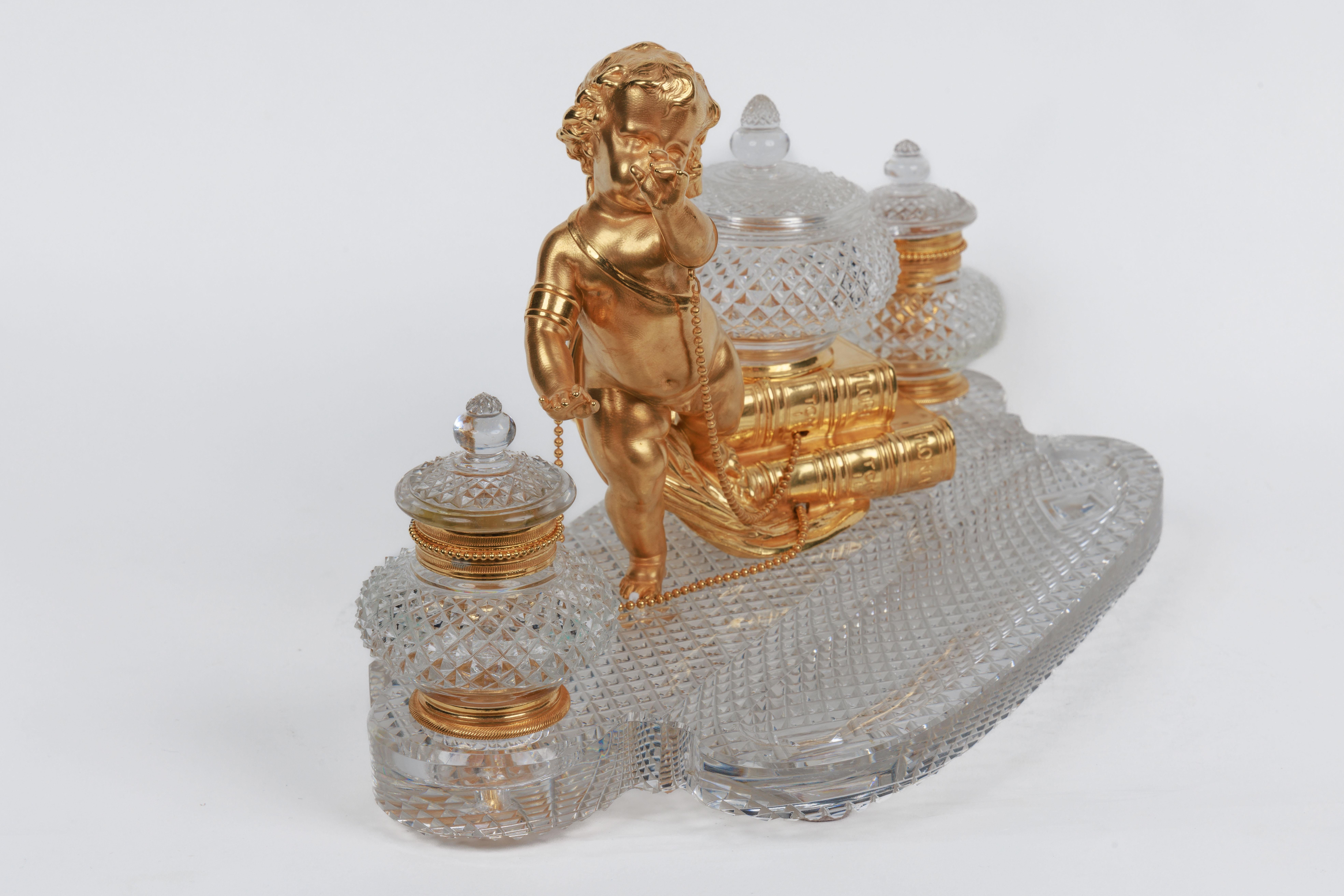 A rare French Ormolu and diamond-cut crystal figural inkwell Encrier by Baccarat, circa 1875.

Depicting a cherub with books, with the finest ormolu mounts, this exquisite jewel-like quality diamond-cut crystal make this inkwell the best of its