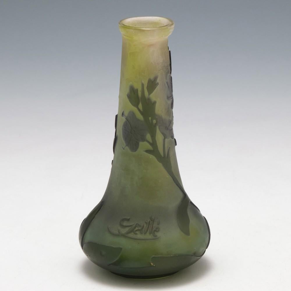 Heading : A Galle Cameo Glass Vase
Date : 1906 -1914
Origin : Nancy, France
Bowl Features :Green leaves quatrefoil mauve flower and leaf overlay against paler green toning towards clear at the toprim
Marks : G with the epsilon bisecting the lower