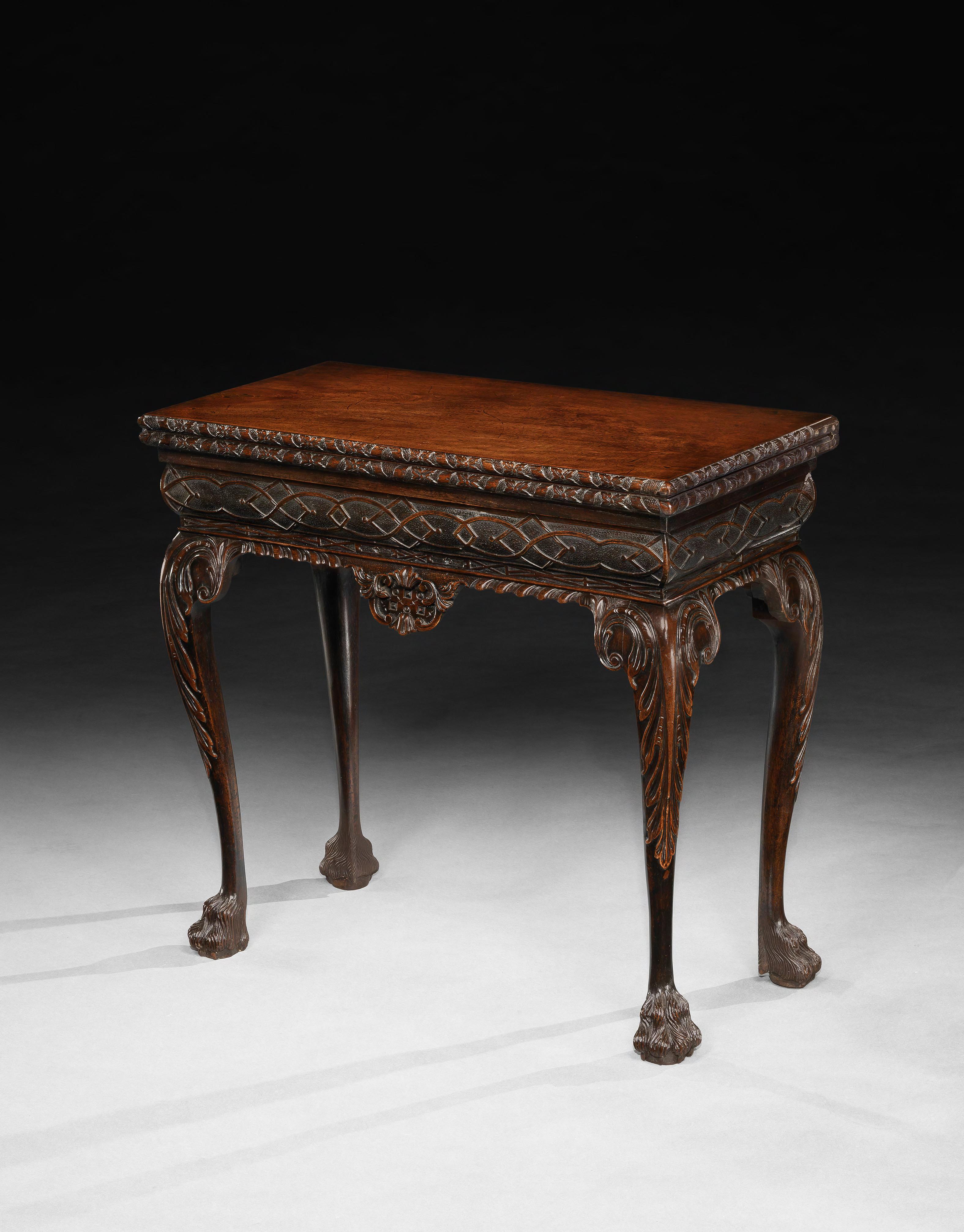English, circa 1745

The rectangular, solid mahogany top is exquisitely carved with ribbons and floral ornamentation above a convex frieze finely worked with interlaced strapwork and set over a richly gadrooned moulding. The four cabriole legs are