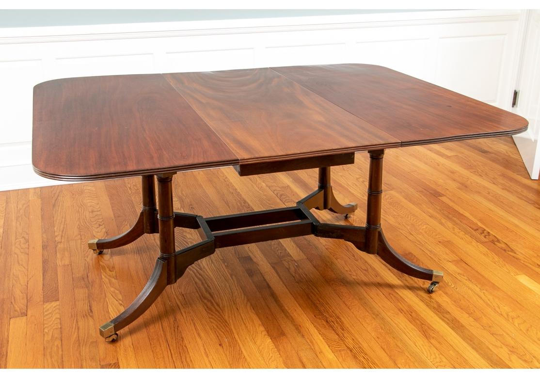 A fine and rare Cumberland action dining table on four saber legs, each of which solid brass swivels. Gate legs pull out to support the drop leaf extensions. Cumberland action tables are rare and few come up in the market. the gate legs pivot at the