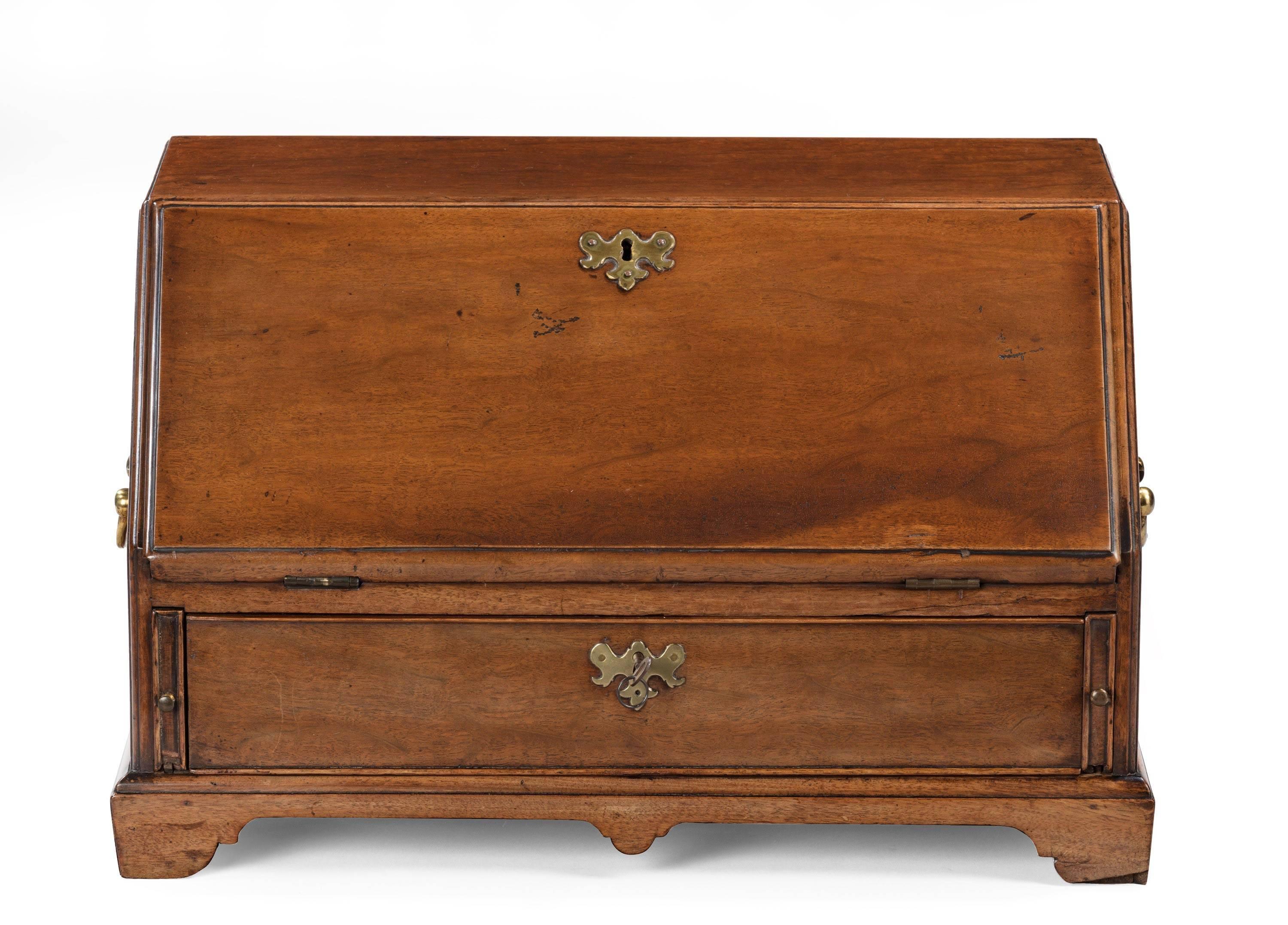 An extremely good and rare George III mahogany table bureau. With the most wonderful shaped serpentine interior. The outer case evenly faded and patinated, 1760.
