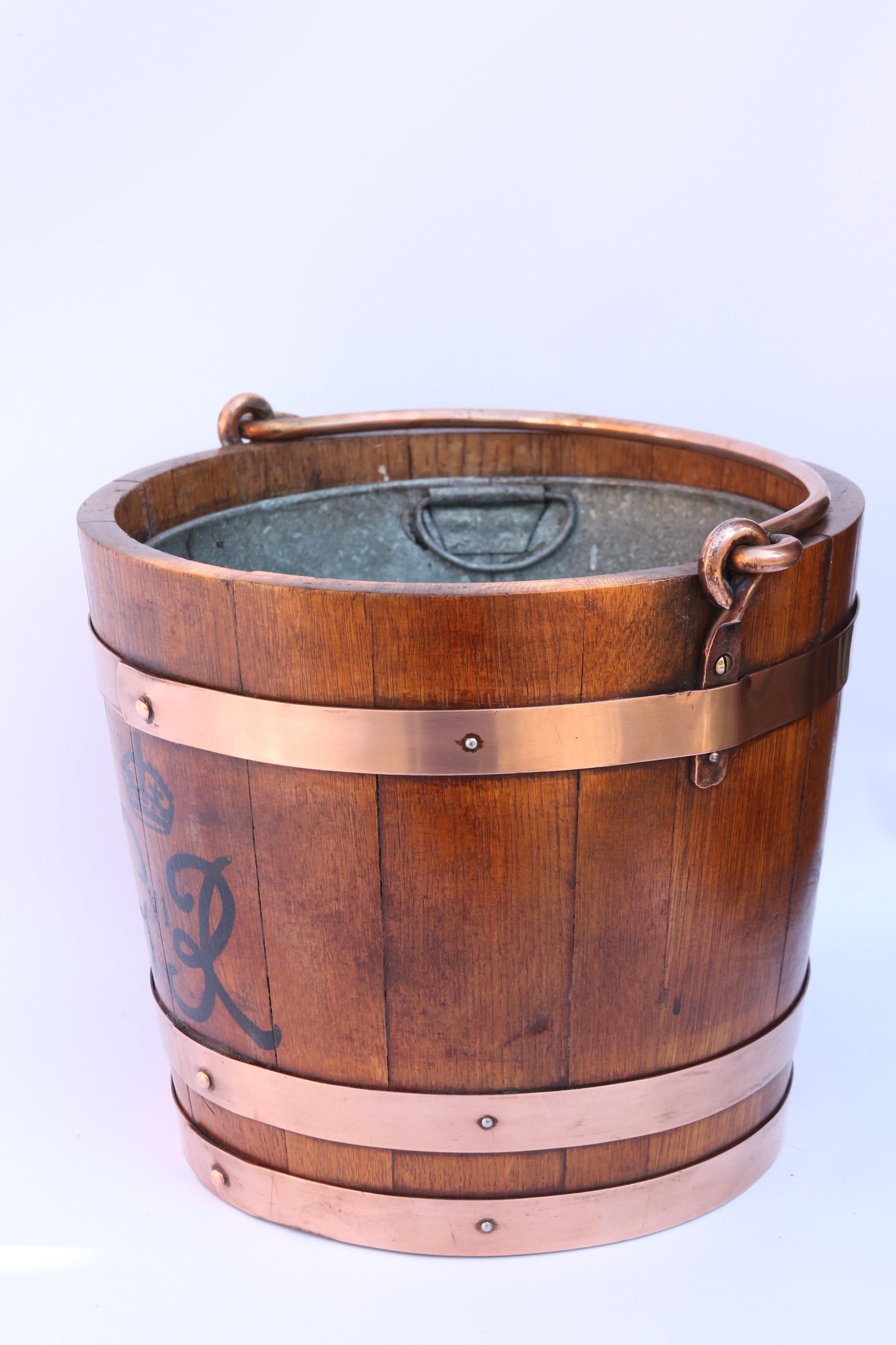 A rare hand coopered English oak bucket traditionally made and bound in copper held in place with rivets and screws.
This bucket was made to commemorate the coronation of George VI in 1936. It is hand painted with his crown and cipher. The bucket