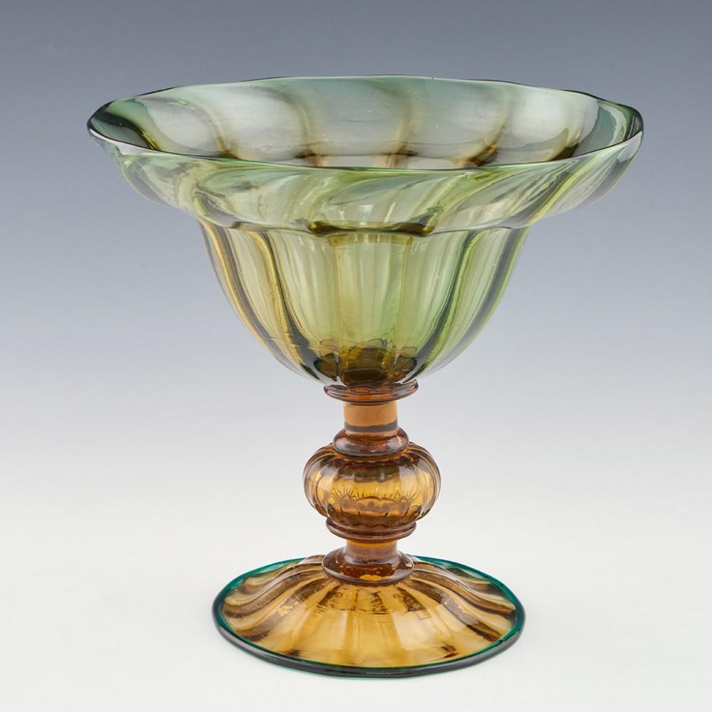 Heading : gray-stan standing bowl.
Date: c1930.
Origin: England.
Colour: amber and green with amber tones.
Bowl: amber with a lipped bowl and wave moulding.
Stem: amber glass capstan plain stem sections above and below a hollow ribbed