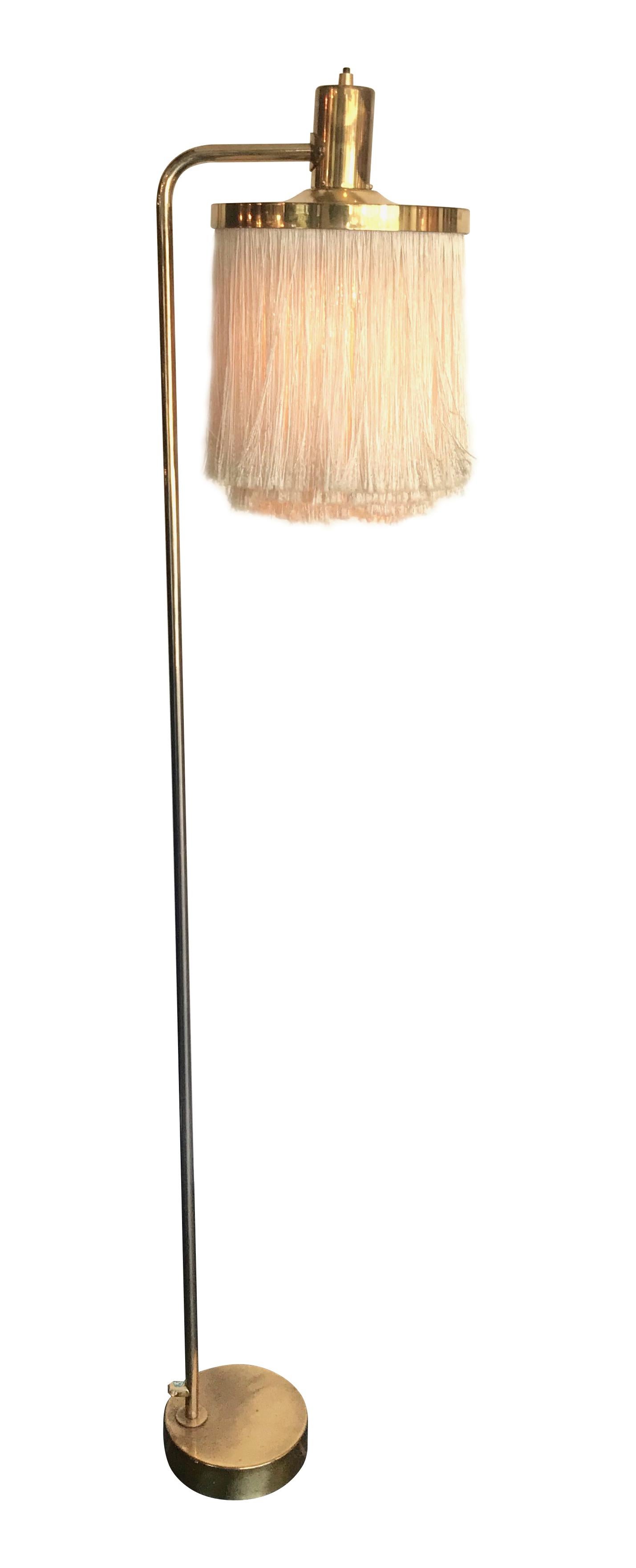 A Hans-Agne Jakobsson silk tasselled brass floor lamp. This is the rare G-109 model and has been re-wired with new fittings, antique gold cord flex and PAT tested.