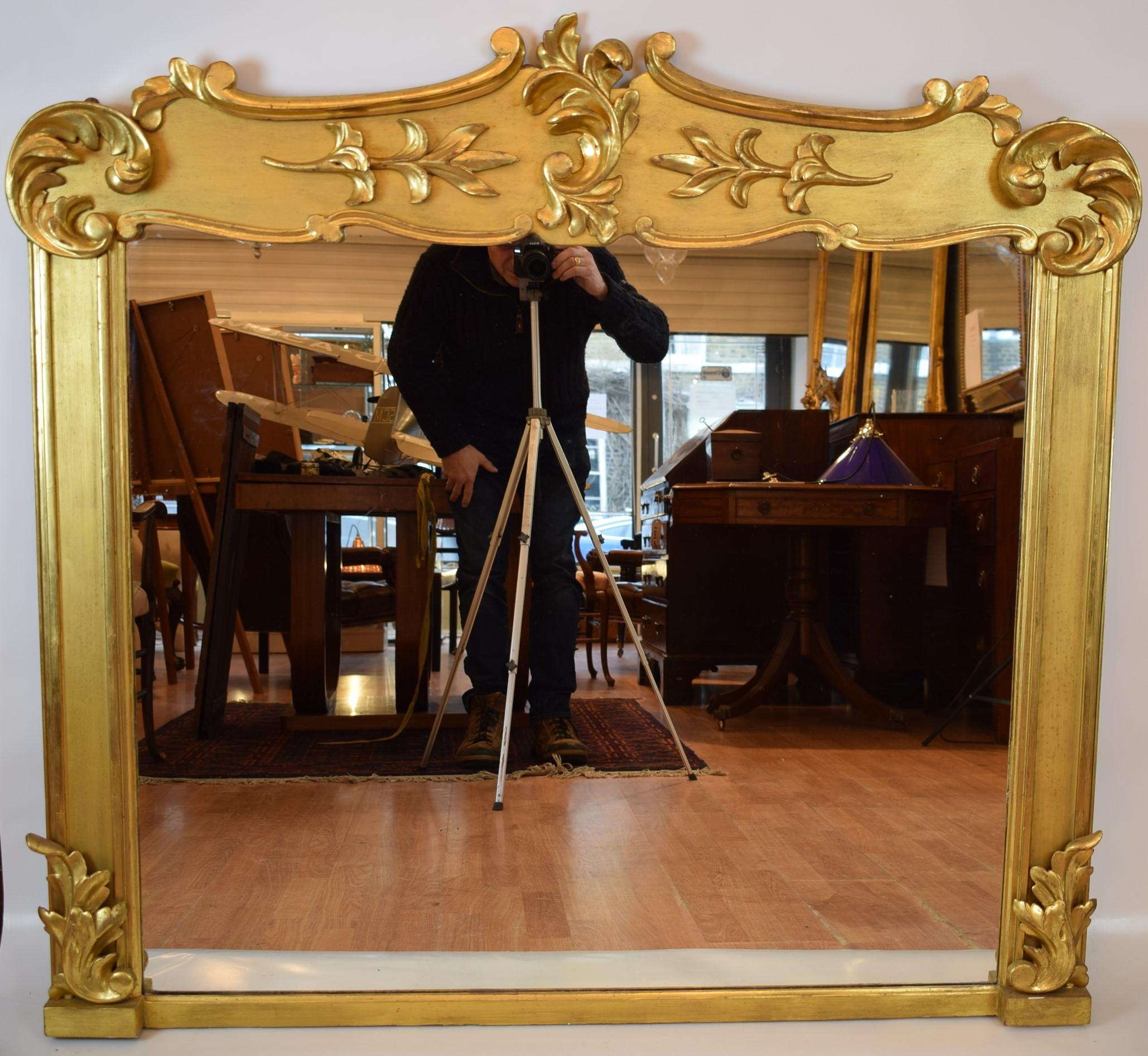 A rare Irish antique gilded overmantel mirror with very good original mercury glass and excellent gilding with a depth of warm gold.
The proportions of this mirror are excellent and hard to find. This shape is often very desirable for lower ceiling