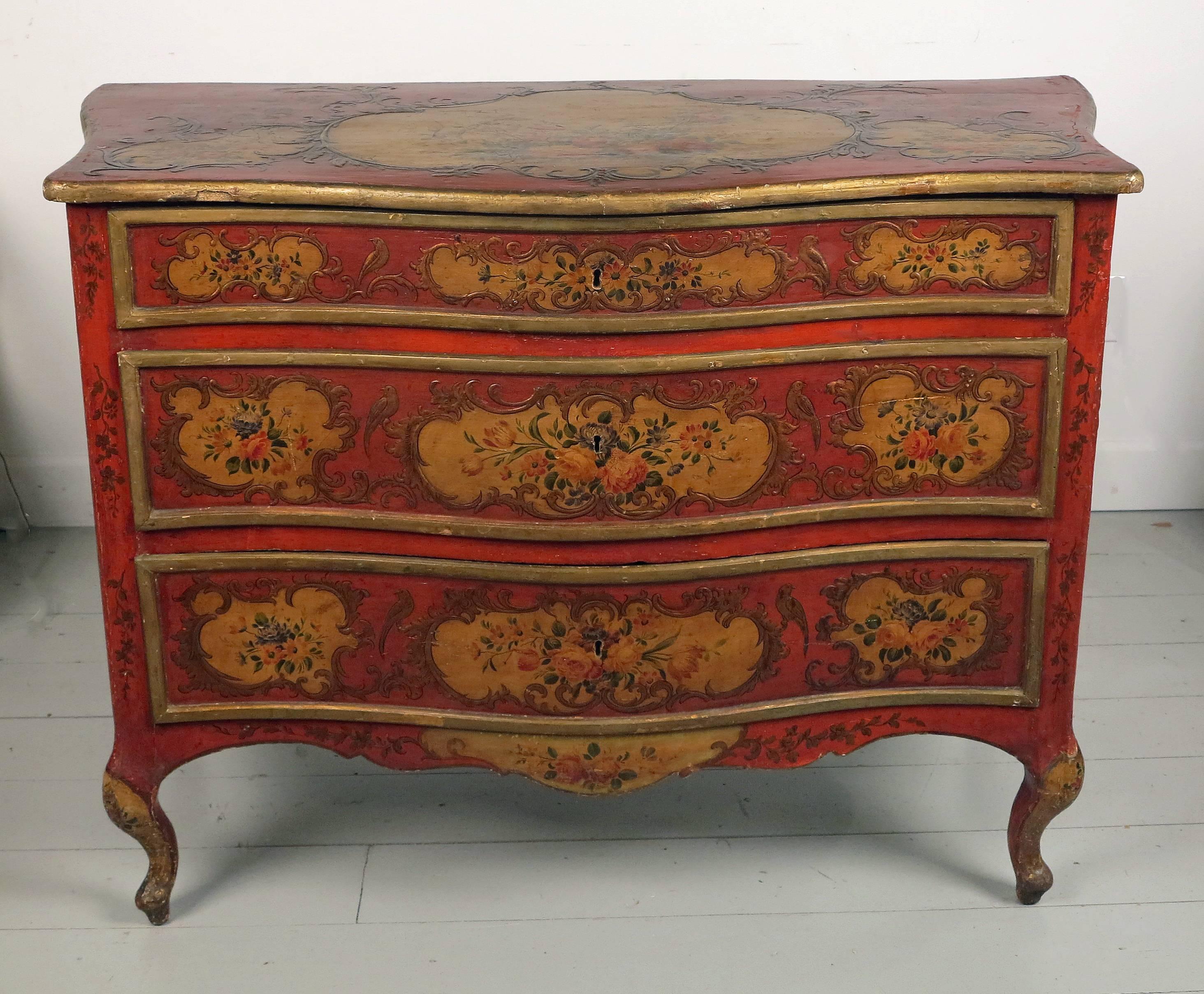 A rare Italian Sicilian red scarlet and polychromed
Rococo style commode
19th century.

The shaped top over three graduated drawers above a shaped apron all resting on four cabriole legs.
Decorated throughout with floral designs incorporating