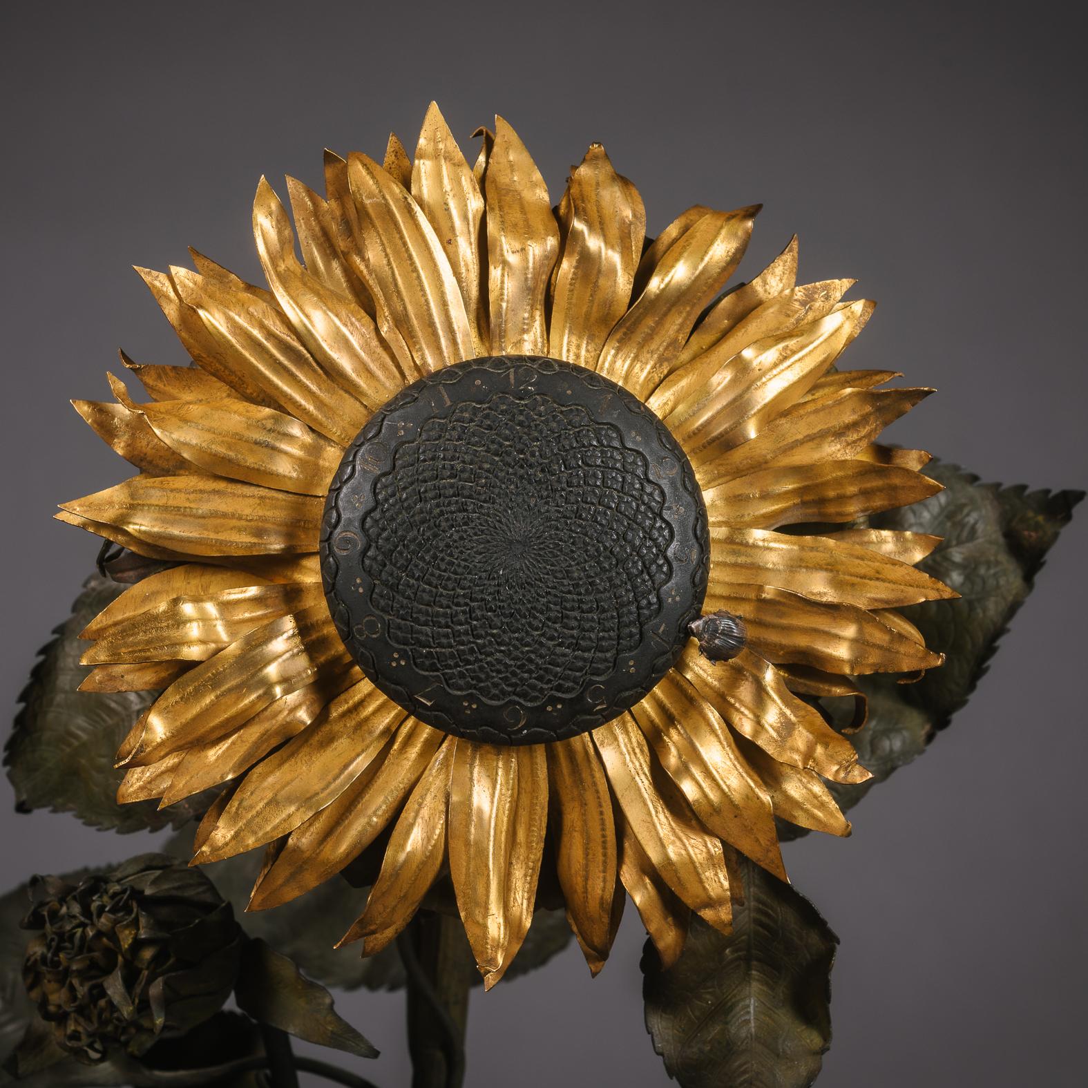 'Pendule Fleur d'Hélianthe' - A Rare 'Japonisme' Cut-Crystal Glass, Gilt and Patinated Bronze Clock by Baccarat, Paris.

Stamped 'Baccarat', The clock movement signed 'Planchon à Paris'.

The sunflower stem is suspended in an ovoid glass body