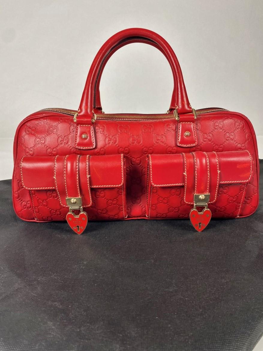 Circa 2013
Italy
Rare limited edition red leather GG logo printed Gucci handbag called Guccissima, numbered 152466-001013 and dating from the 2010s. Front two flap pockets with two Gucci hearts (without key). Gold metal zip top closure with Gucci