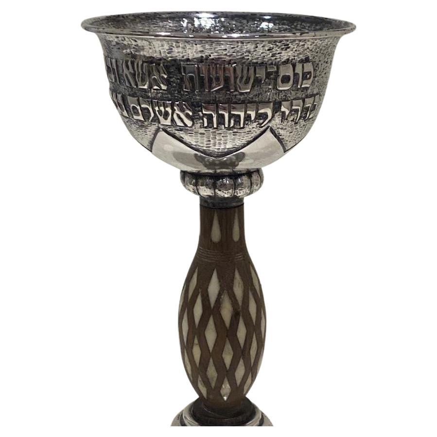 An exceptional silver kiddush cup by friedlander. Dusseldorf Circa .1932. Chased with a verse and the upper portion is hand hammered. Marked B. Friedlander Dusseldorf made in Germany. 

