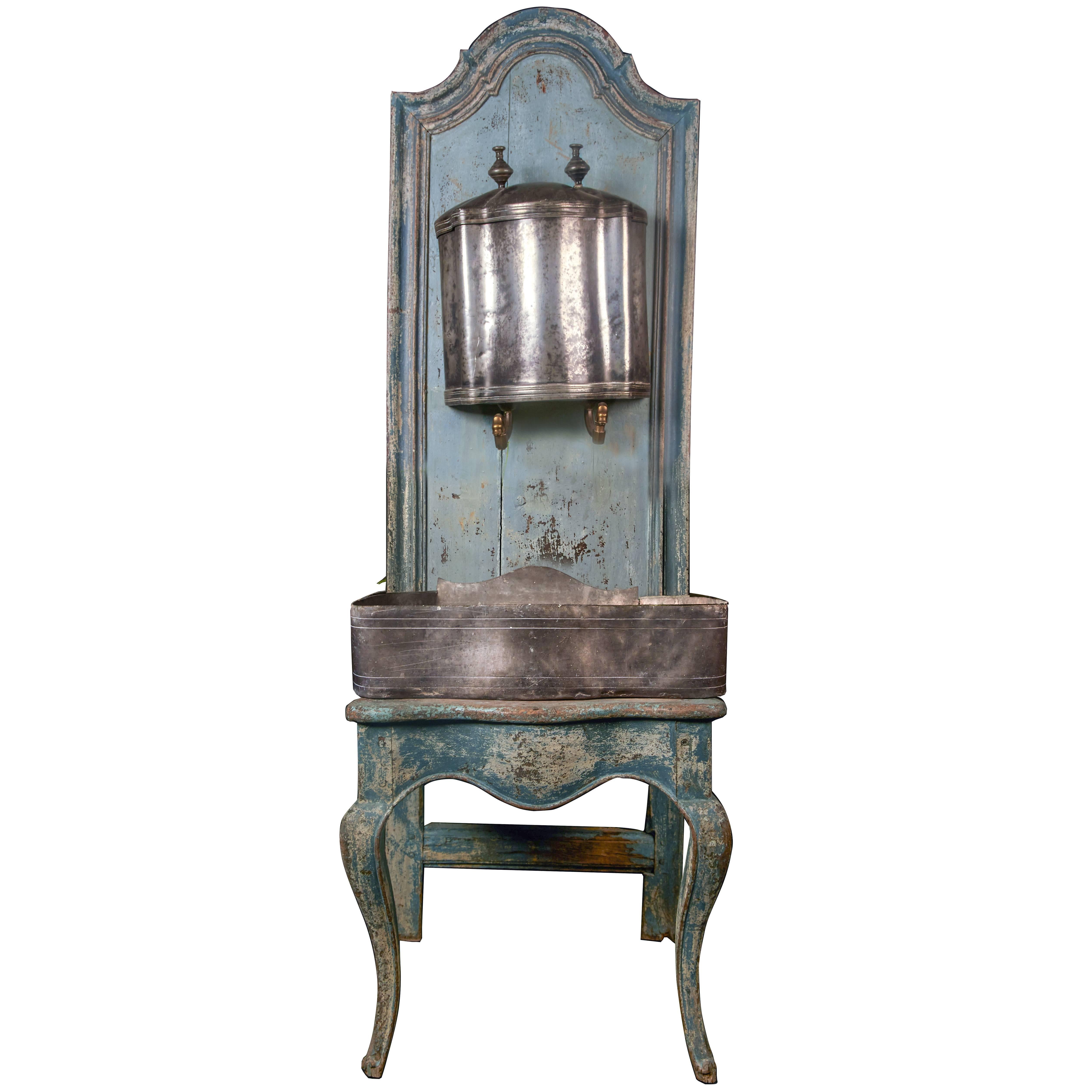 A rare Louis XV wooden throne with zinc water font, 18th century