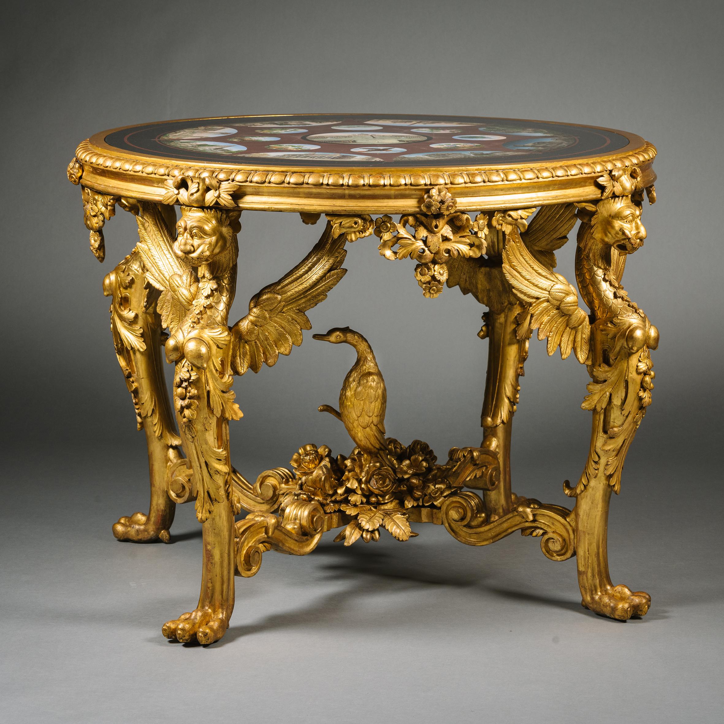 A Rare and Important Micromosaic Inlaid Marble and Giltwood Centre Table.
Attributed to Michelangelo Barberi, Rome. 

The circular top with a border of black marble inlaid with red marble stringing and encircling oval vignettes of Roman monuments