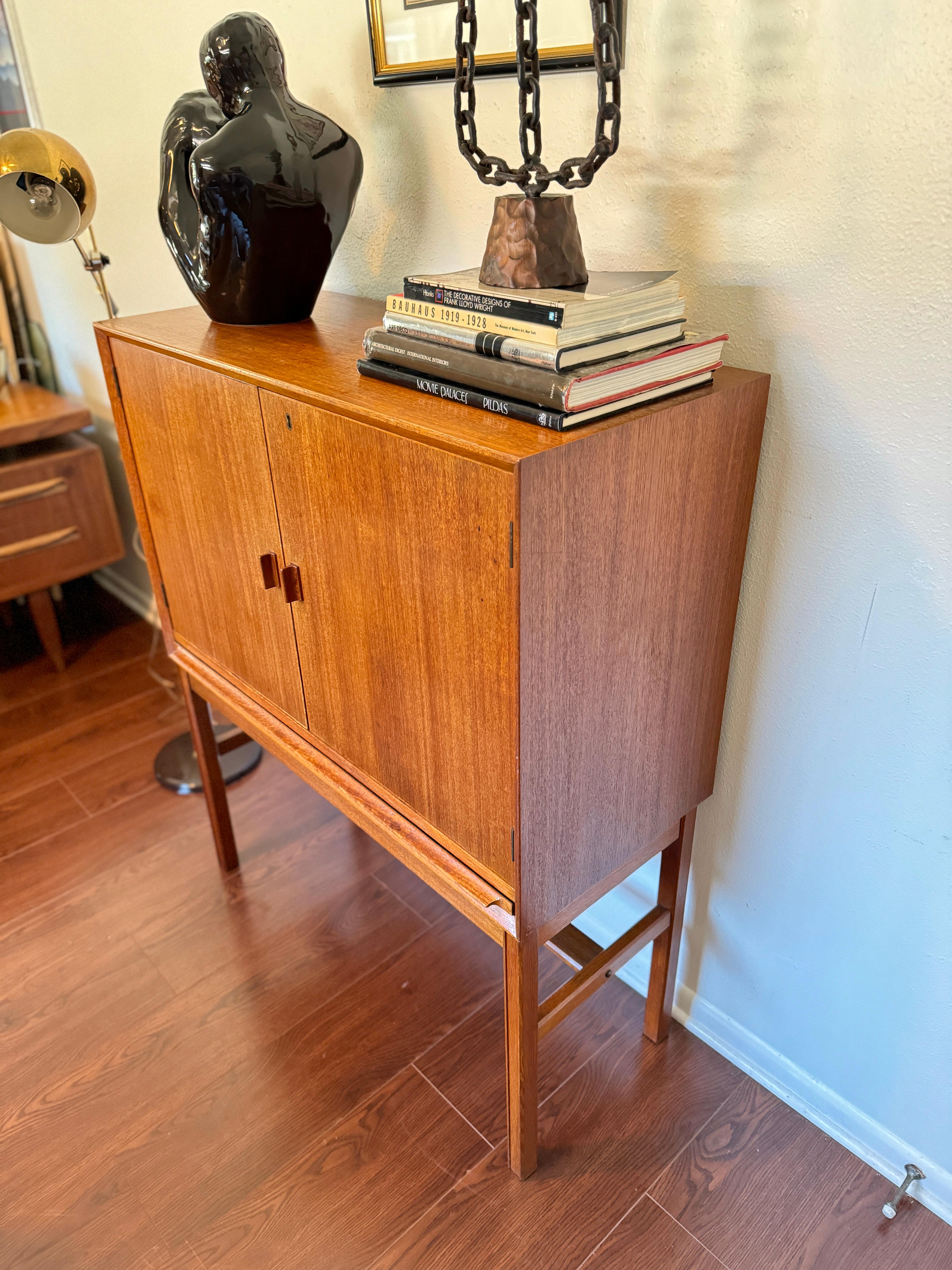 Wood A rare mid century modern tall bar cabinet with a pull out surface